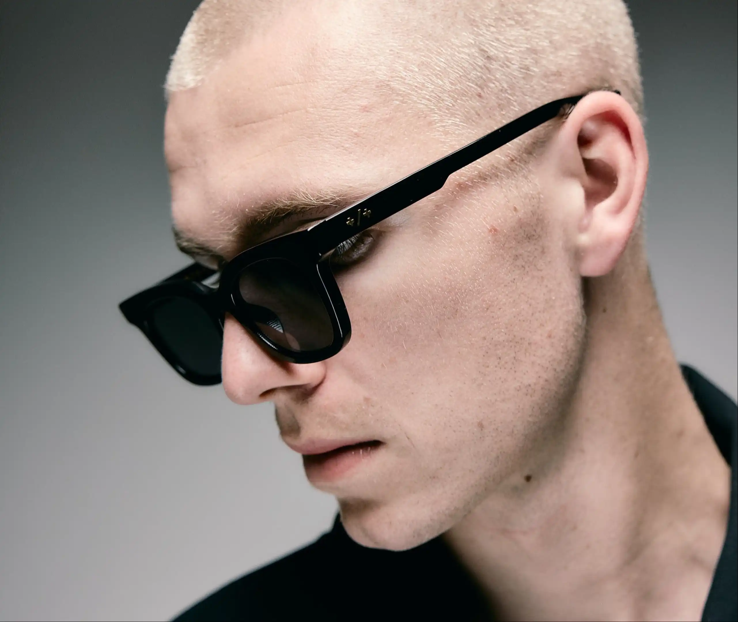 Stack of modern books and magazine with minimalist cover design on leather chair