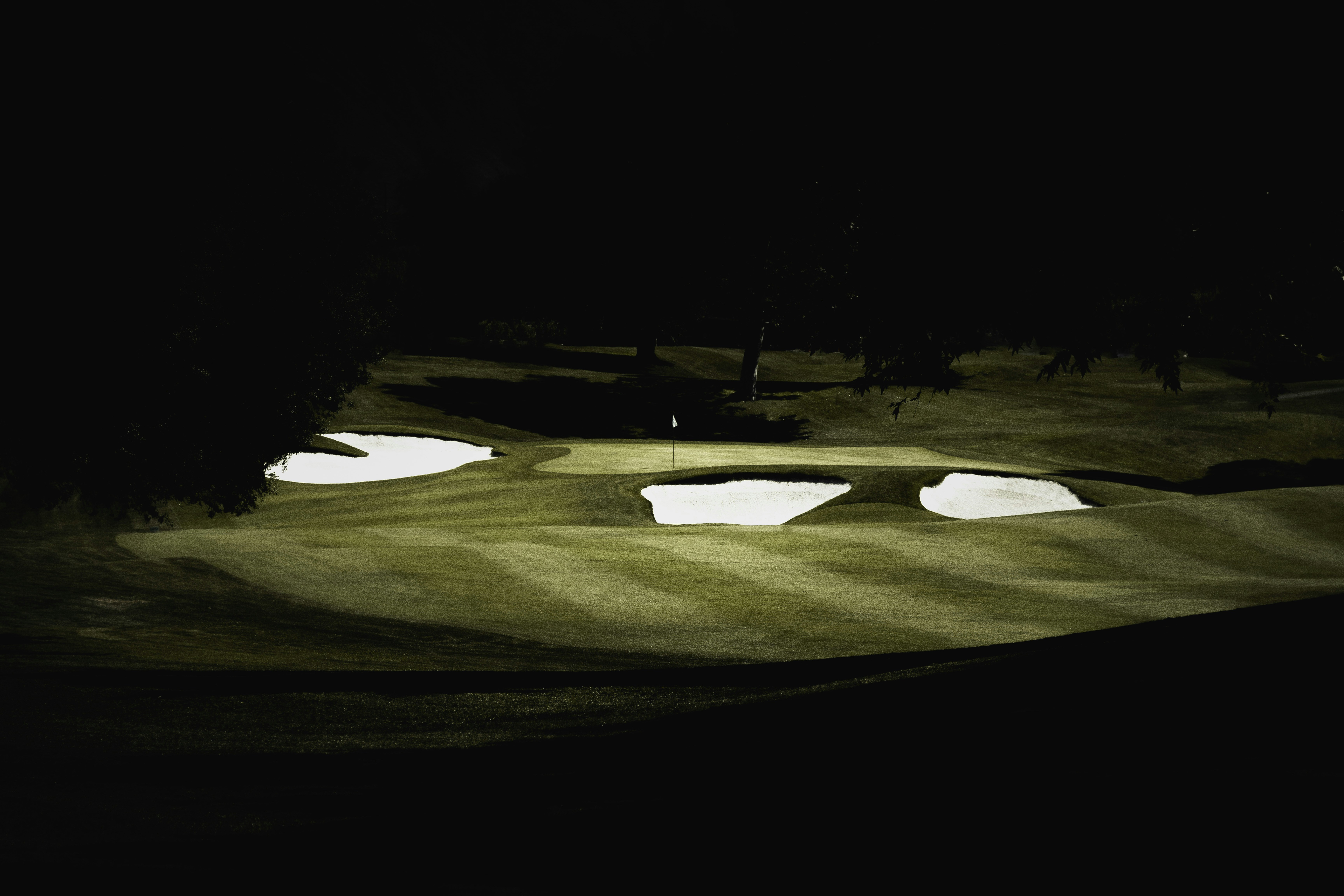 a golf course at night with the lights on