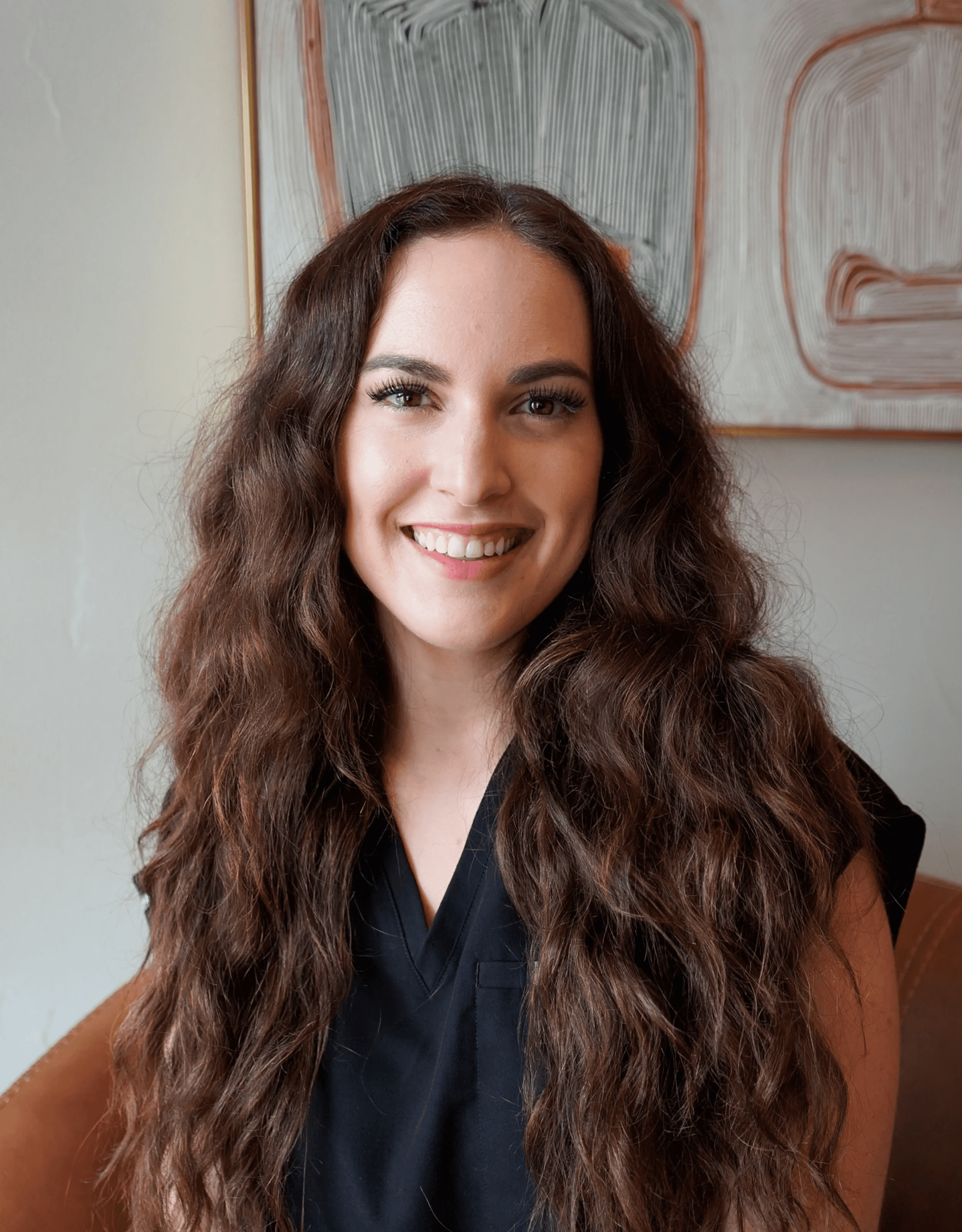 Kassi Picanso in leather chair with cowboy painting in background