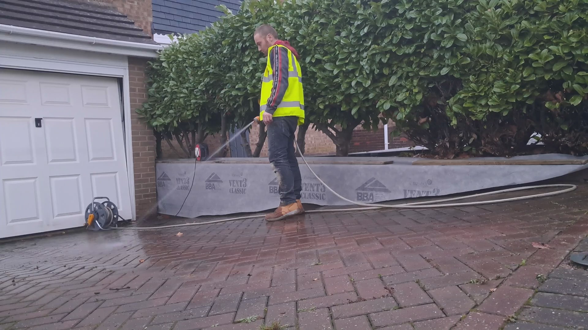 A man hosing down work area