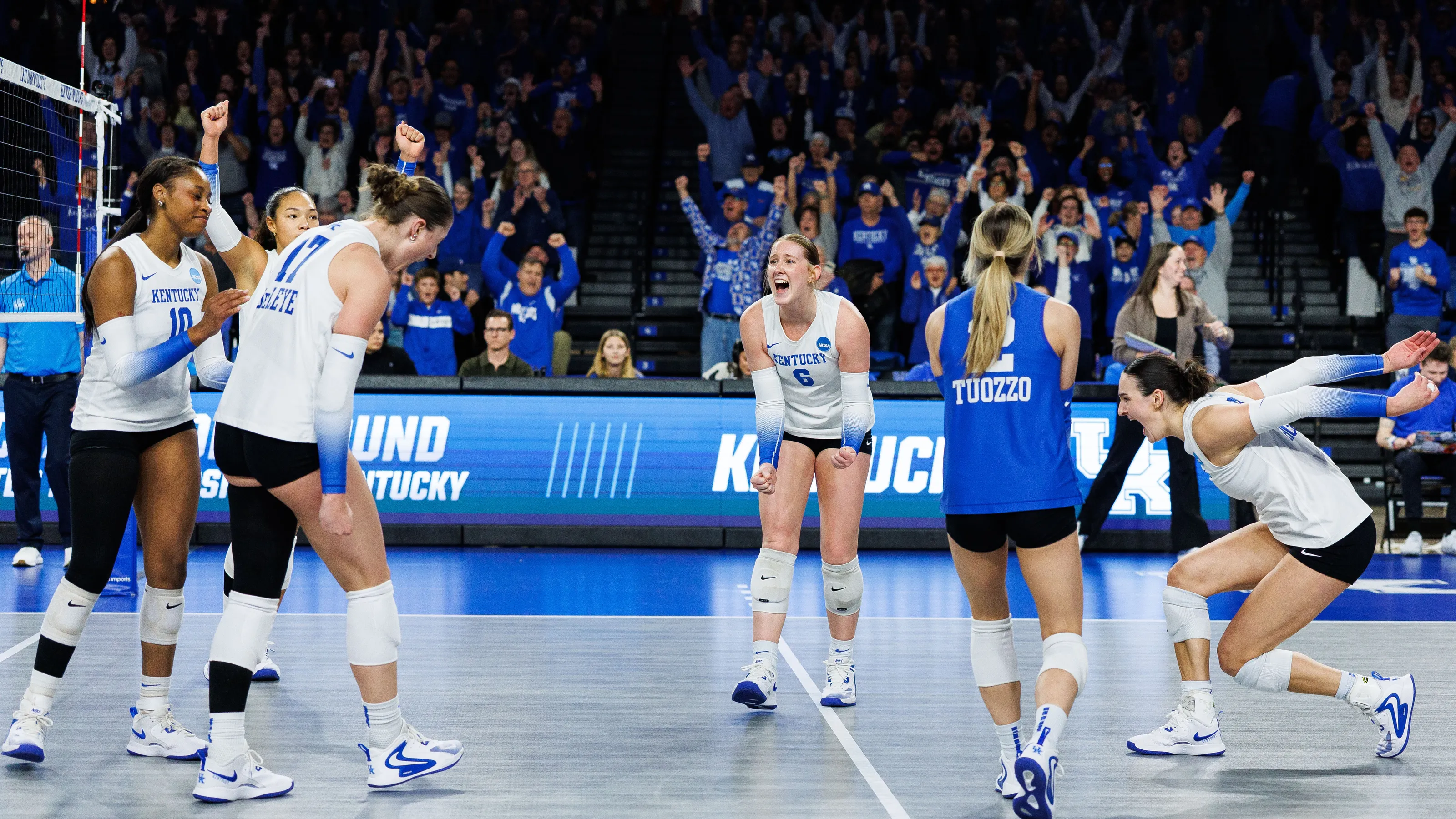 Three people sitting on a couch in a room looking at mobile devices