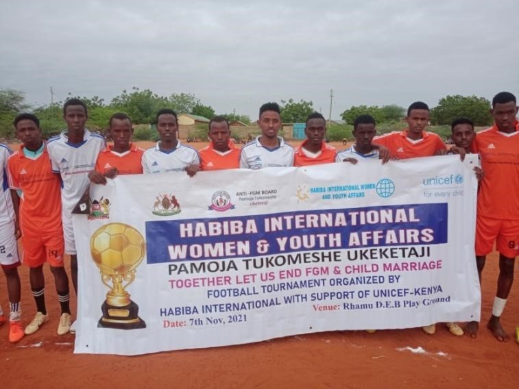 five children smiling while doing peace hand sign