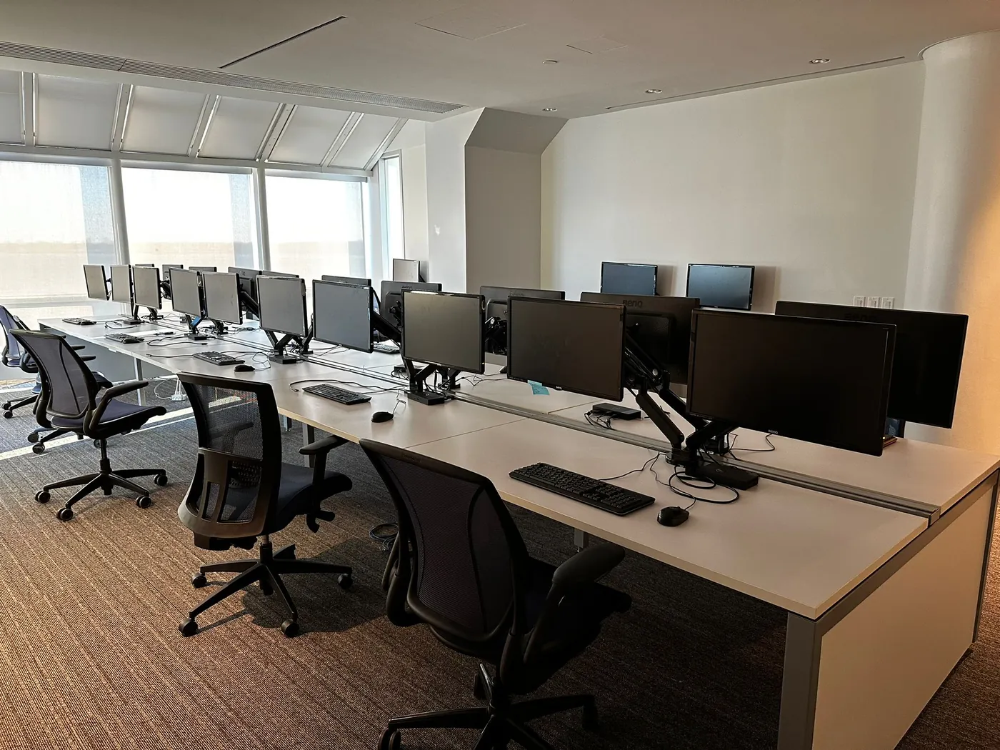 Complete office IT installation with workstation setup, monitors, and desk configuration.