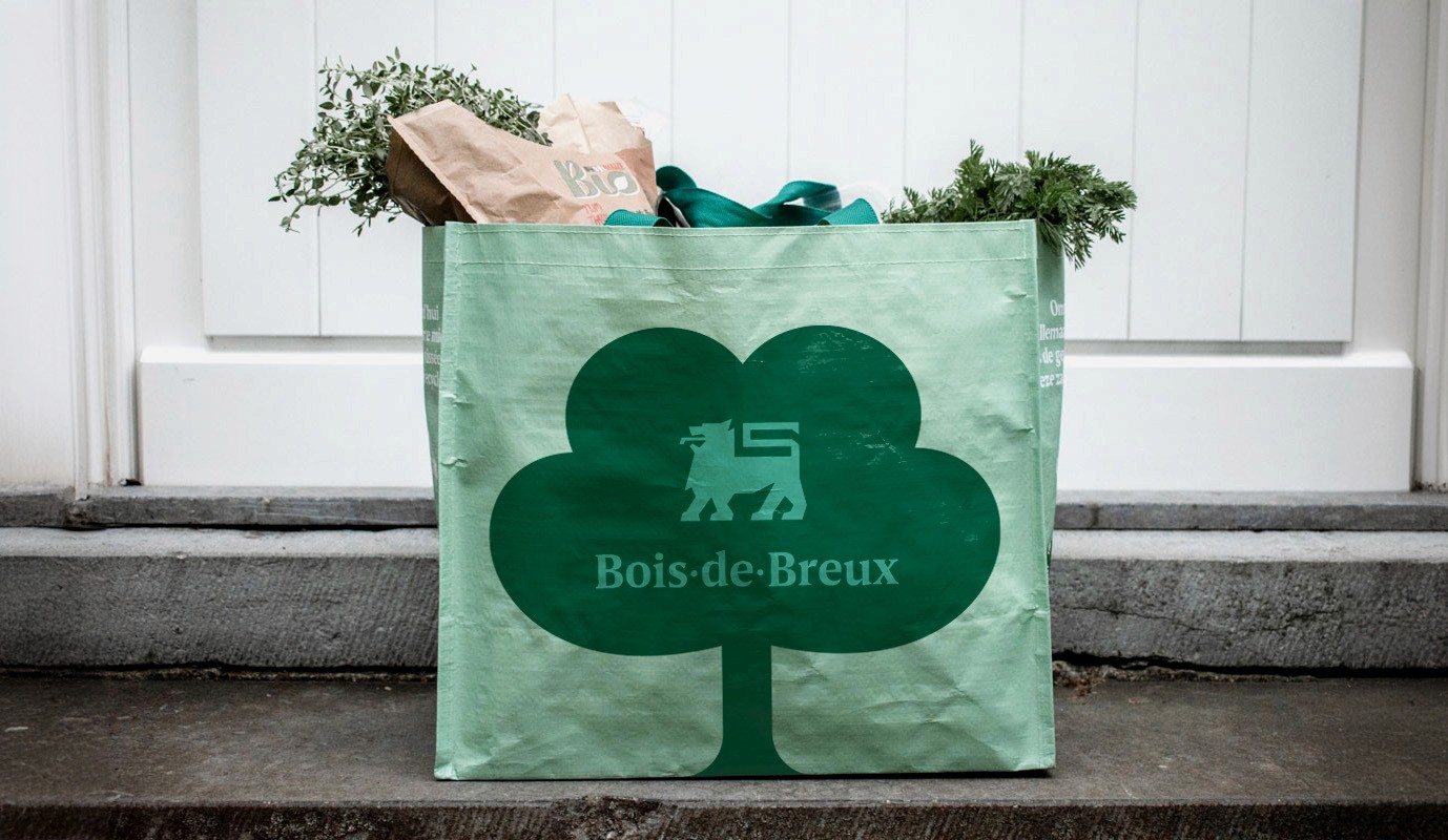 Rectangular packaging box with a pale yellow-to-orange gradient, featuring a large half-smiley face and “Smiley Co” branding, set on a split orange and yellow background.