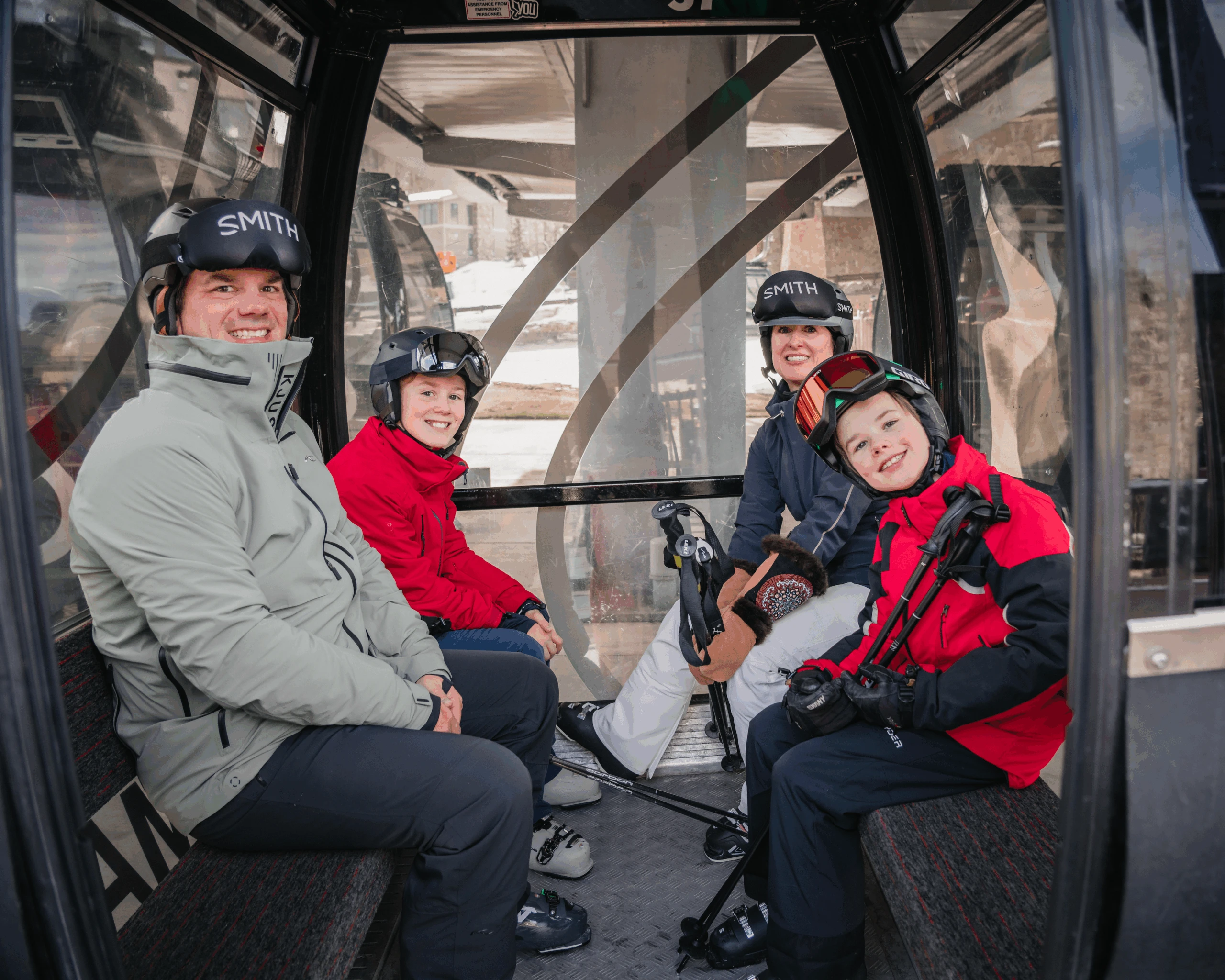 Aspen ski photographer capturing a family laughing together inside the gondola