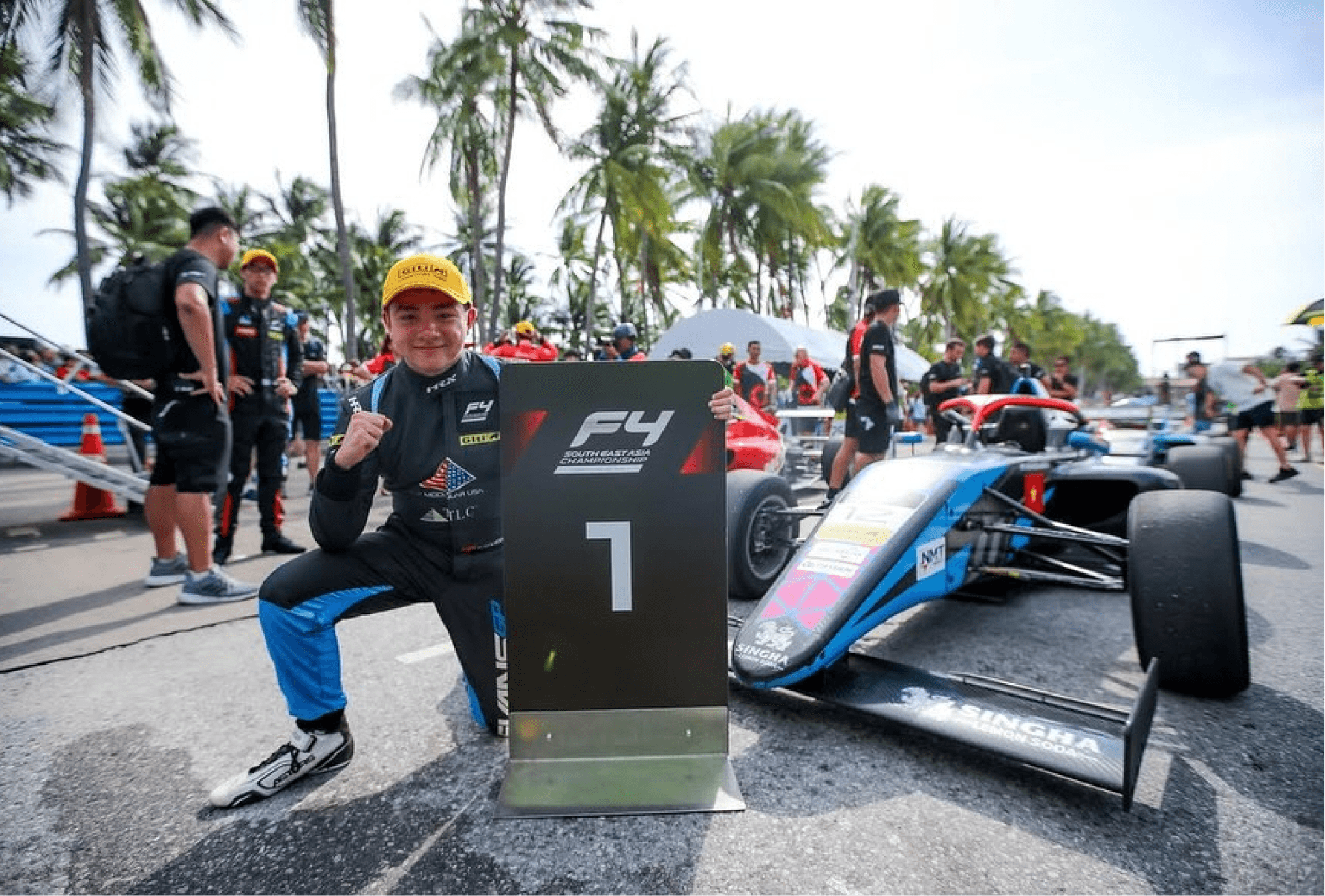 Alex Sawer winning and standing next to his car