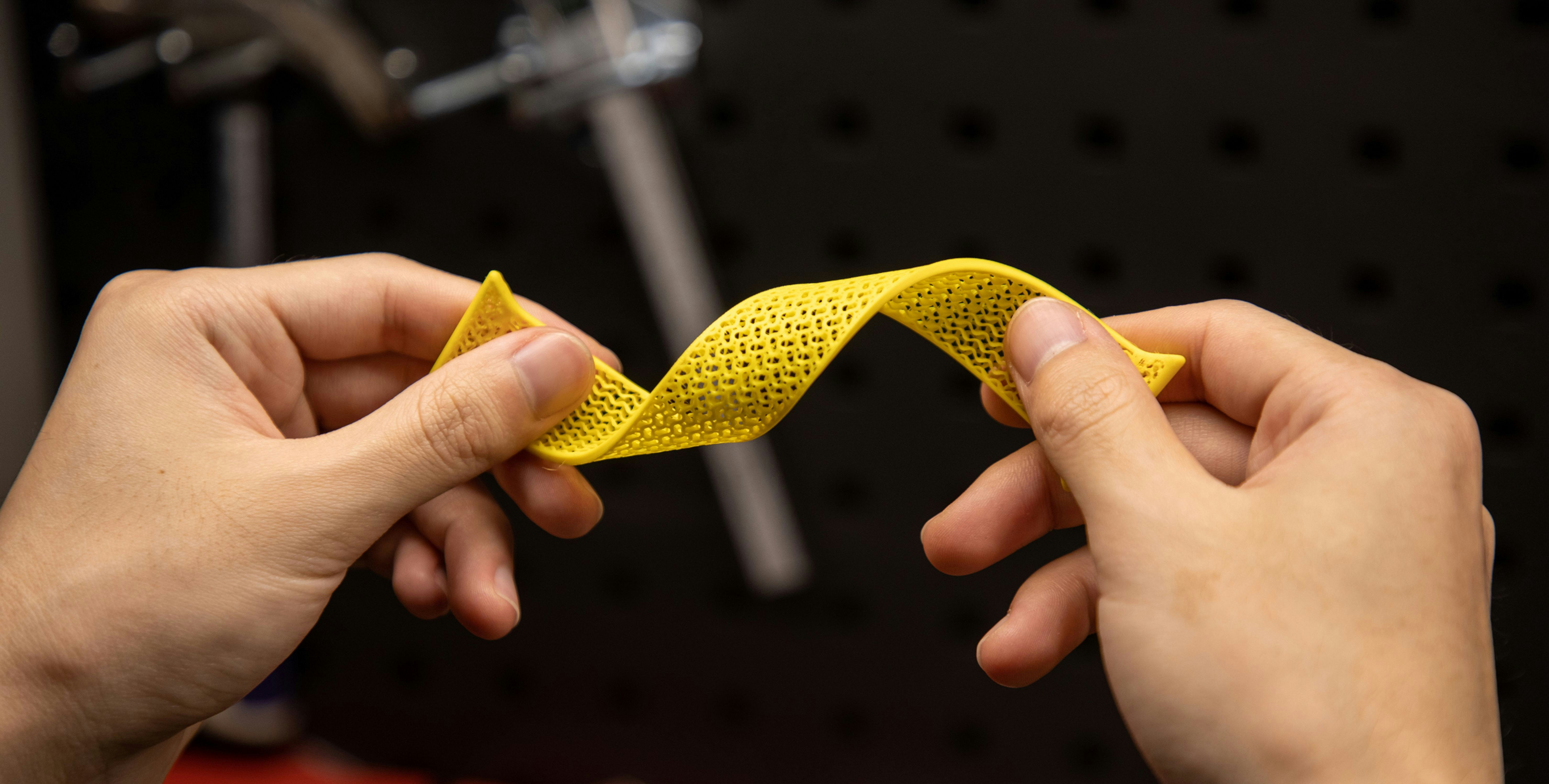 Flexible 3D printed lattice structure being bent by hand
