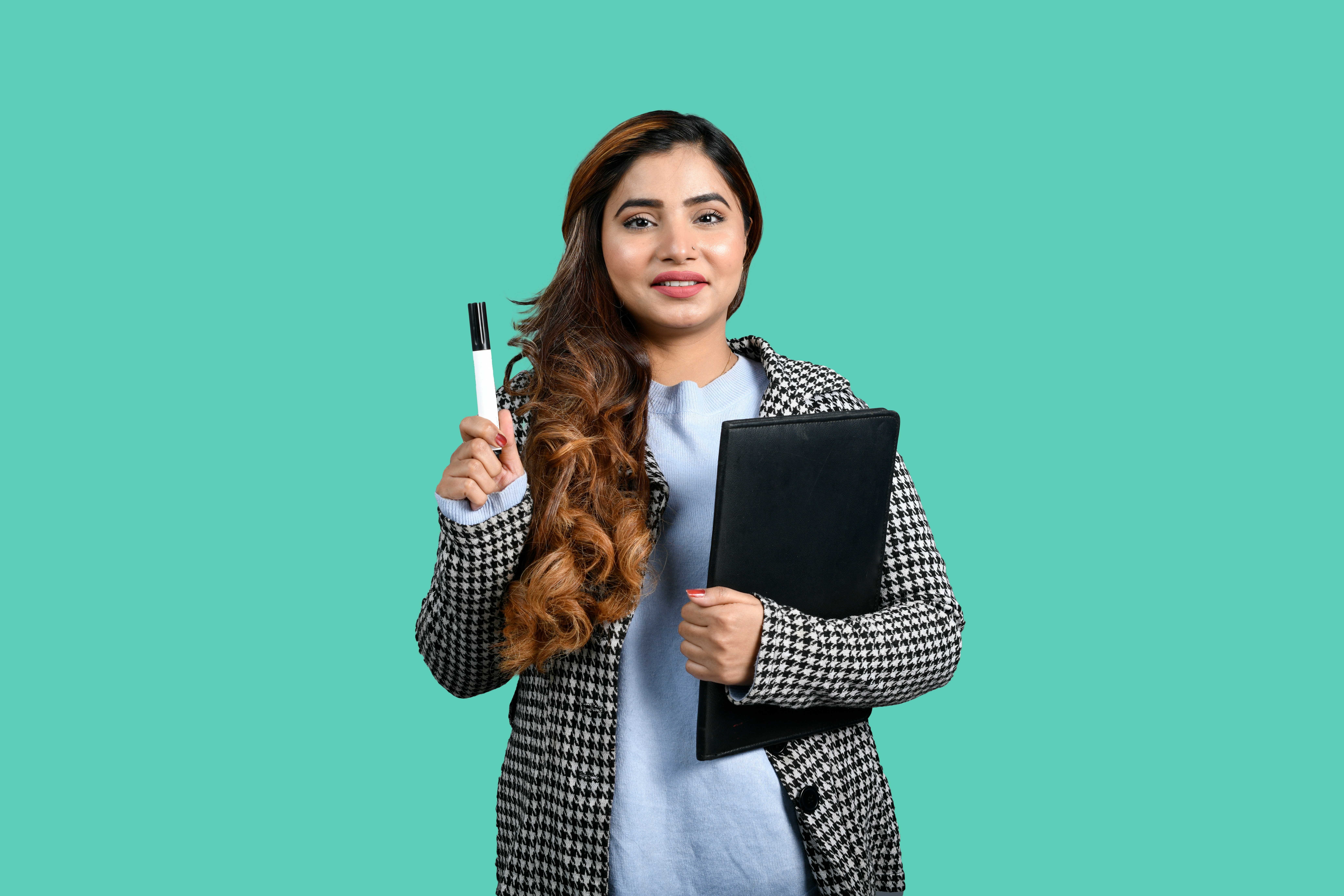 a woman holding a pen and a notebook
