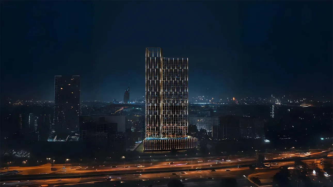  A tall building named Binghatti Vintage, illuminated at night, showcasing numerous windows against a dark sky.