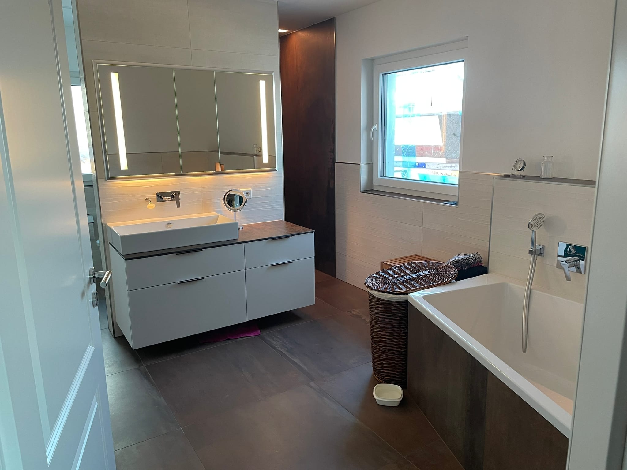 woman sitting around table holding tablet