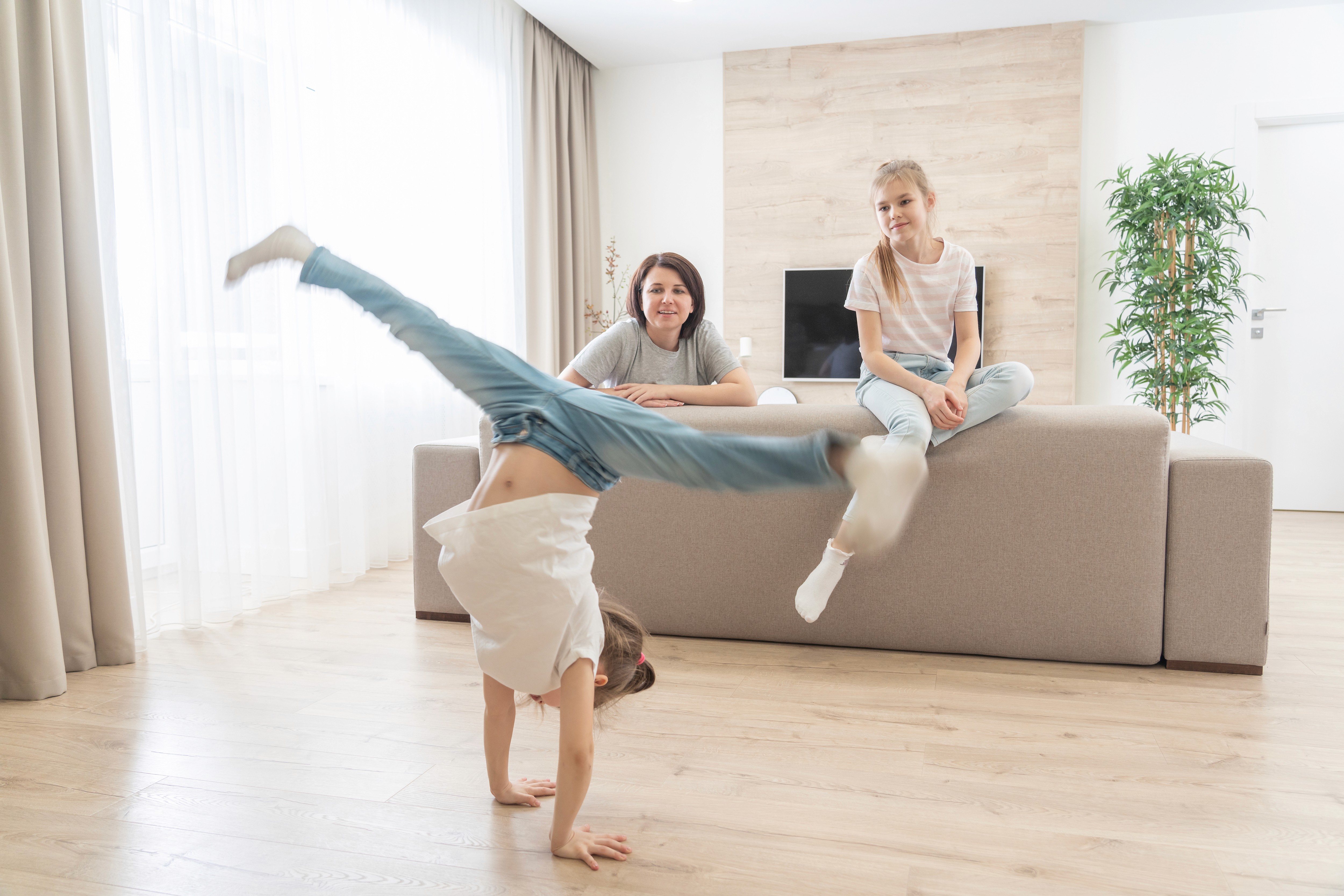 Kids playing freely on slip-resistant hybrid flooring in a Brisbane family home, built to handle spills, scuffs, and everyday mess without stress.