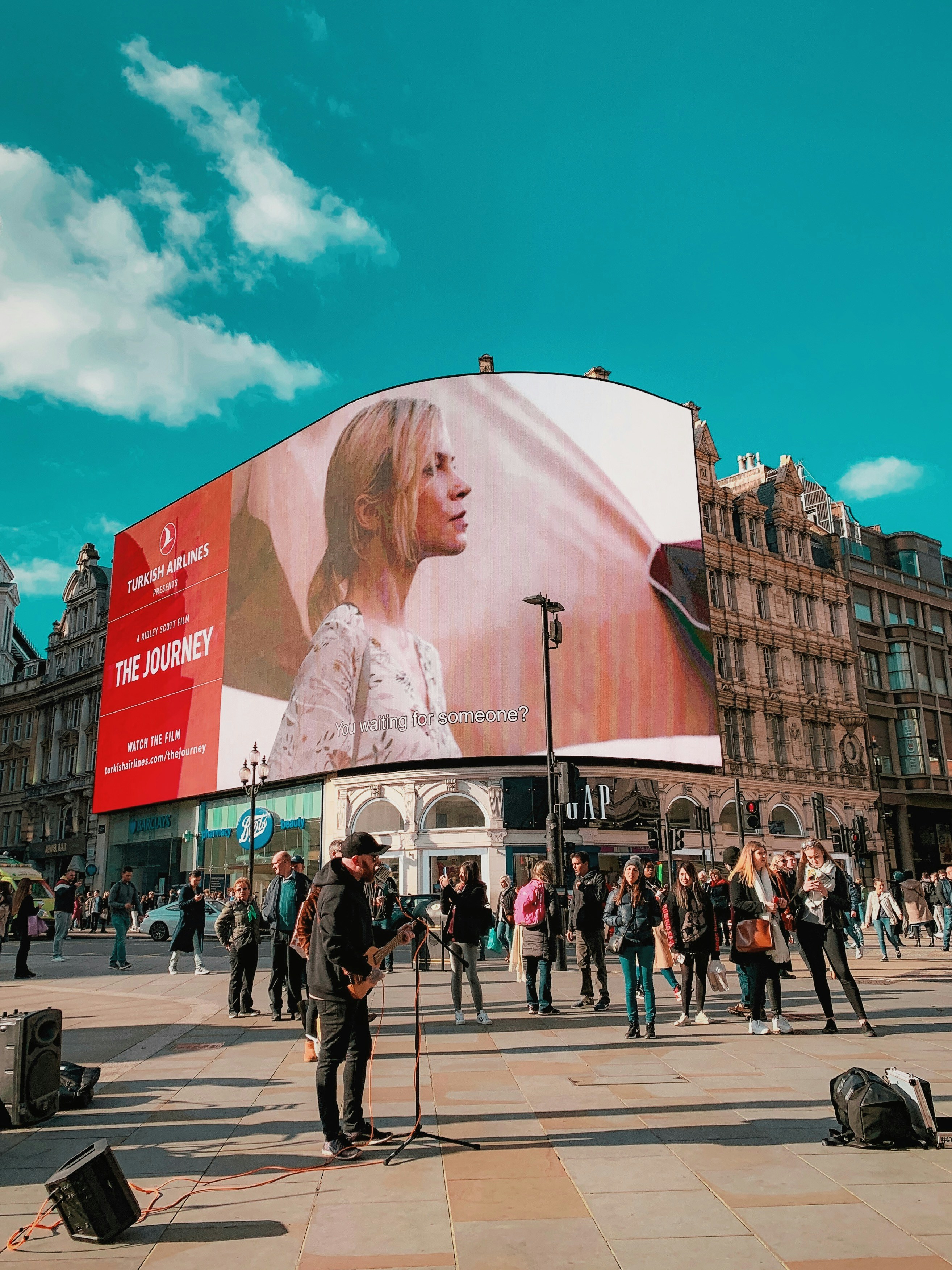 man wearing black jacket performing on street during daytime
