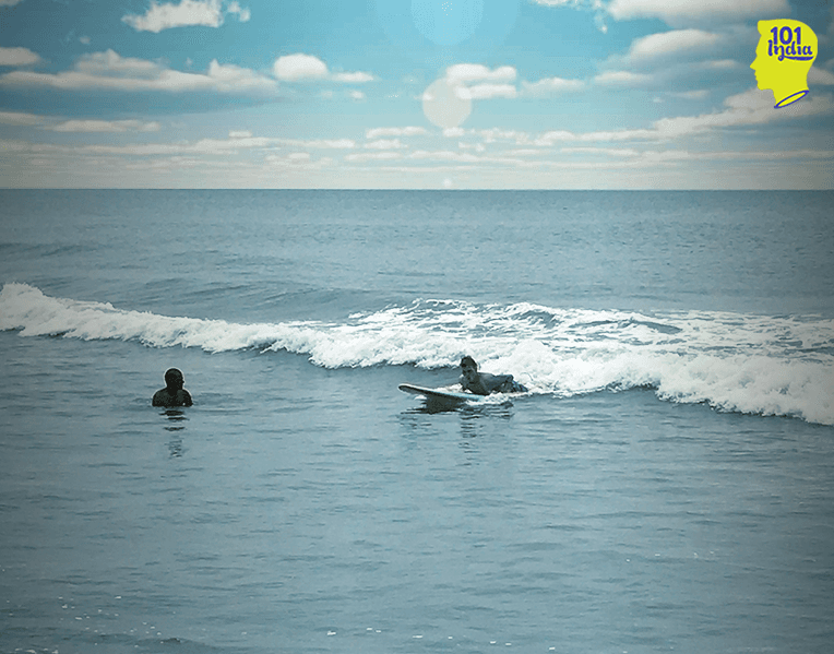 A surfer riding a foam wave