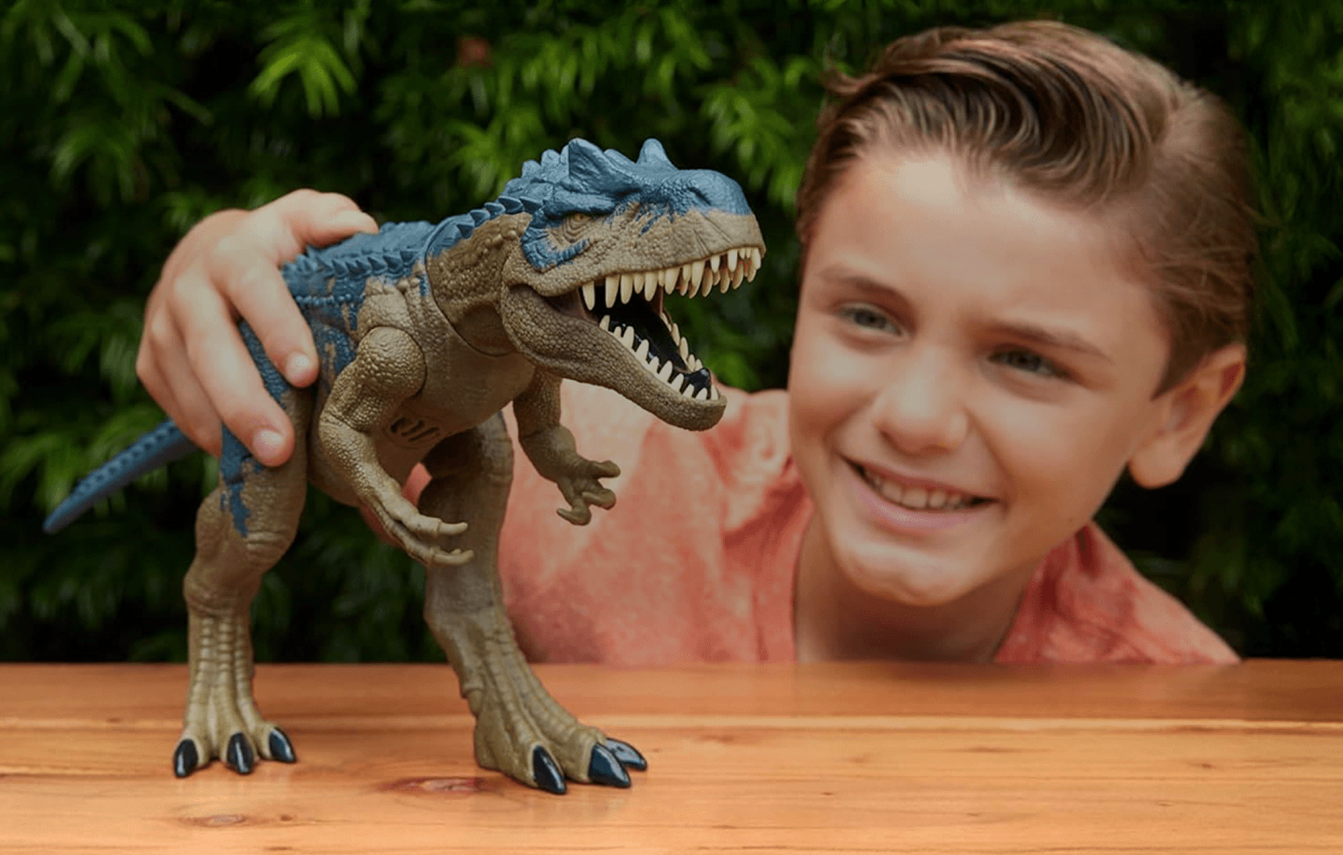 A boy playing with a toy dinosaur