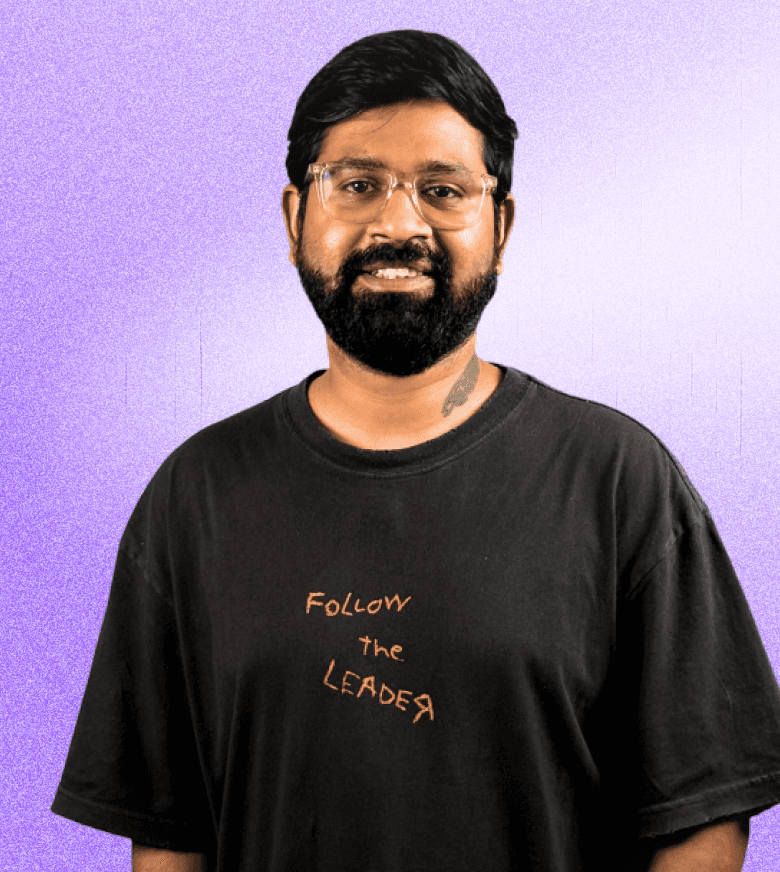 Portrait of Ashutosh Singh, Co-founder & CEO, wearing a black t-shirt with 'Follow the Leader' text, smiling against a light purple gradient background.