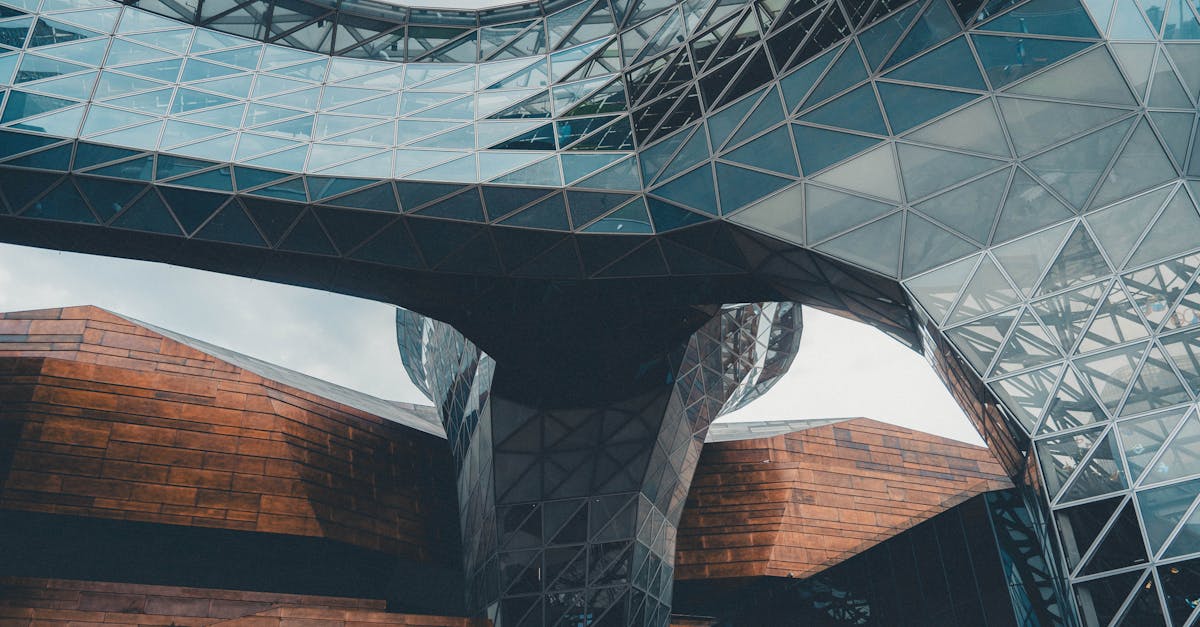 Dynamic view of a modern architectural structure featuring glass and steel elements.