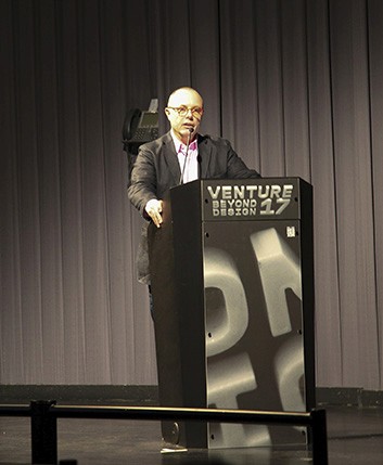 A man talking to the public from the stand
