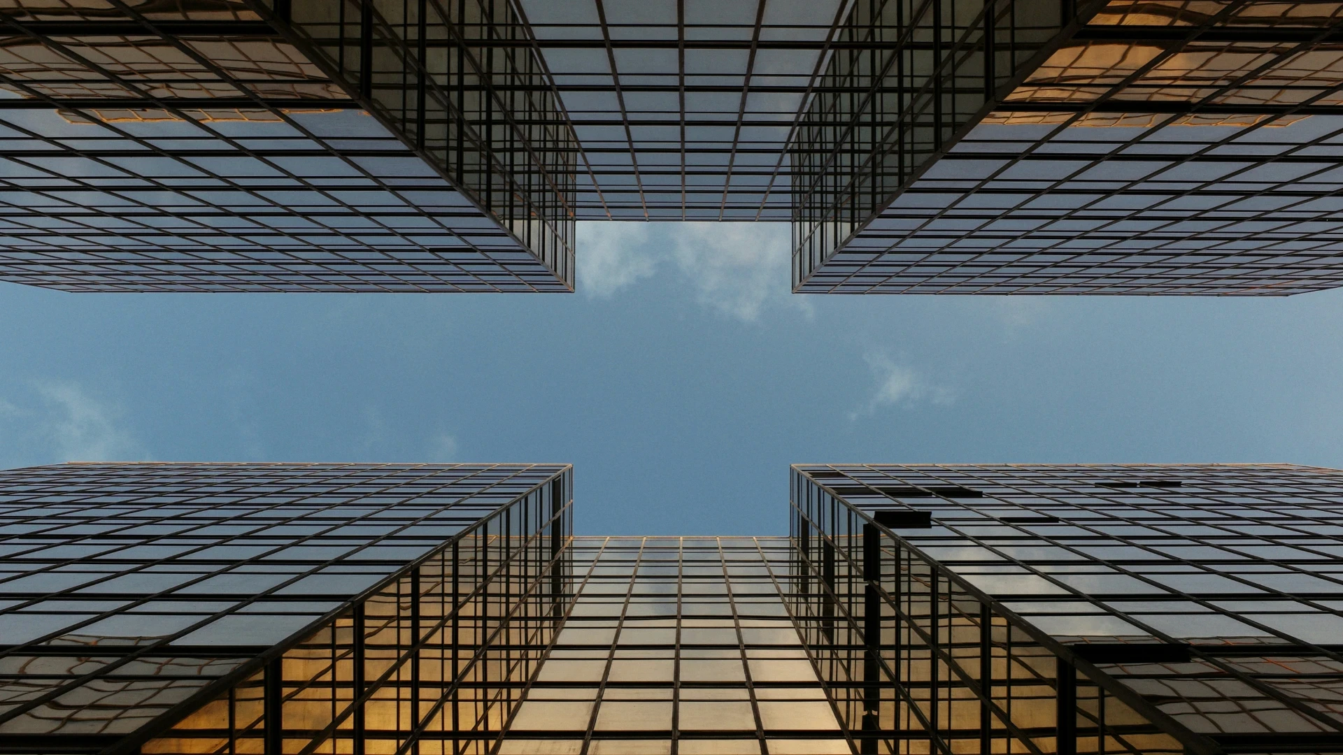 worm view photo of buildings under cloudy sky