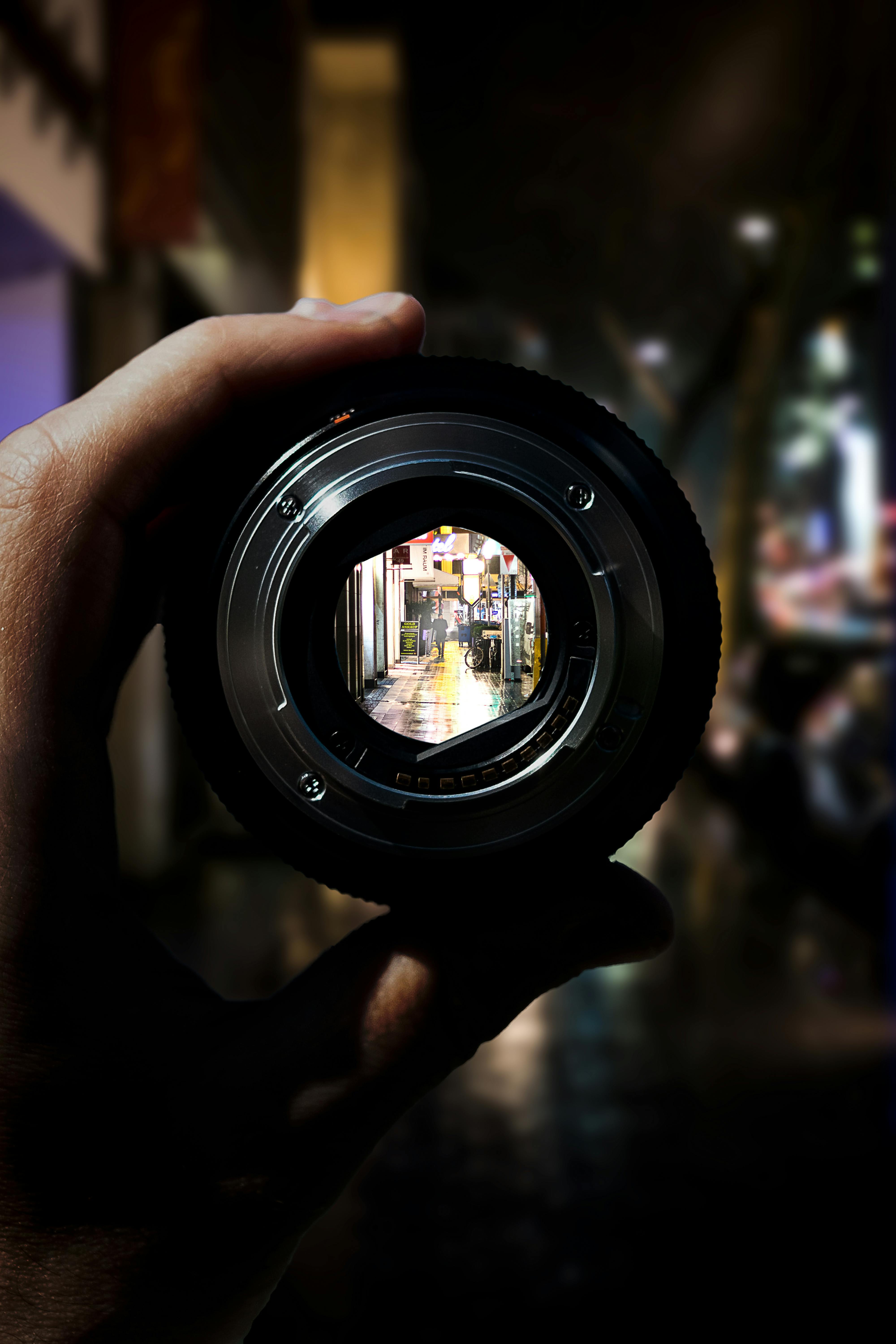 person holding camera lens