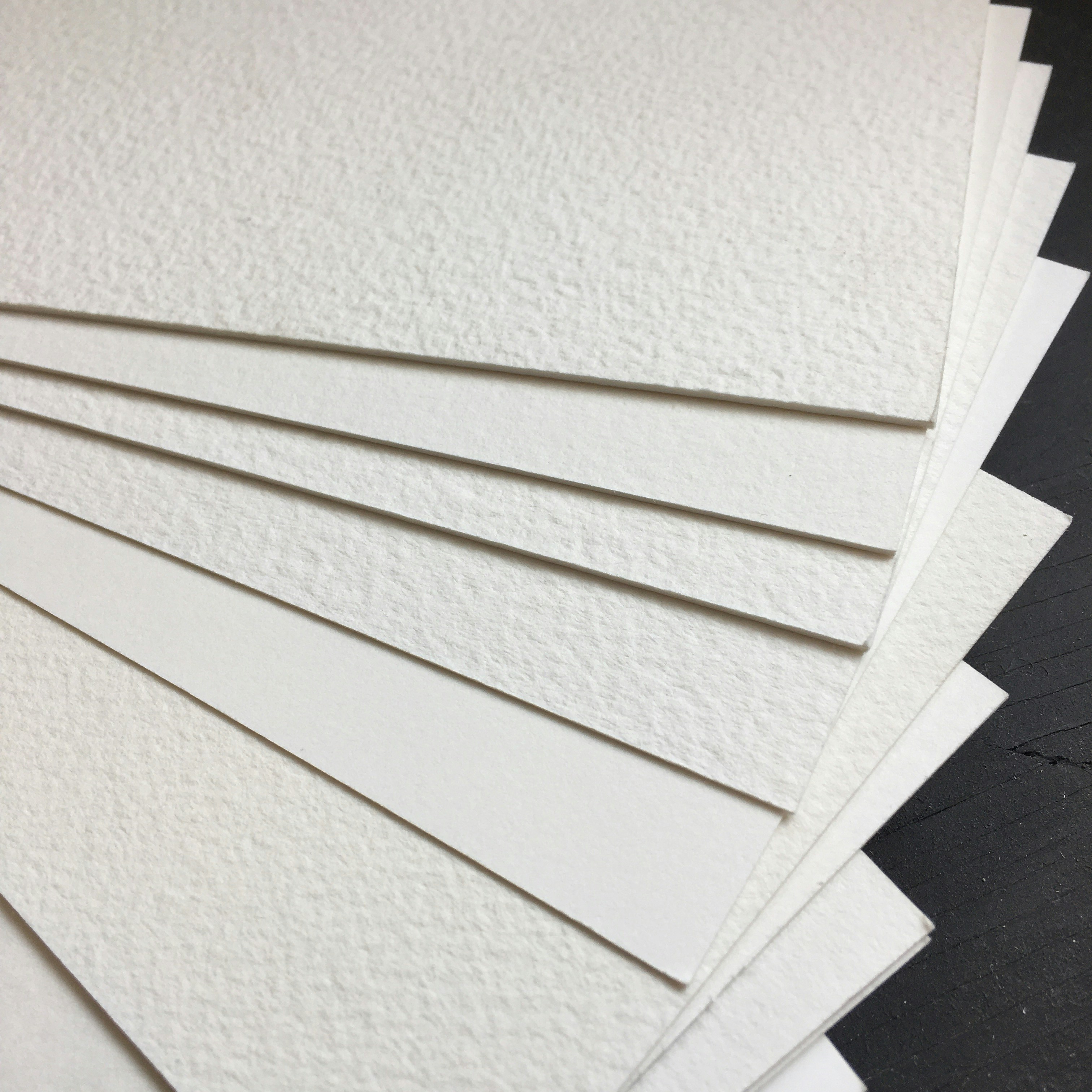 a pile of white paper sitting on top of a table