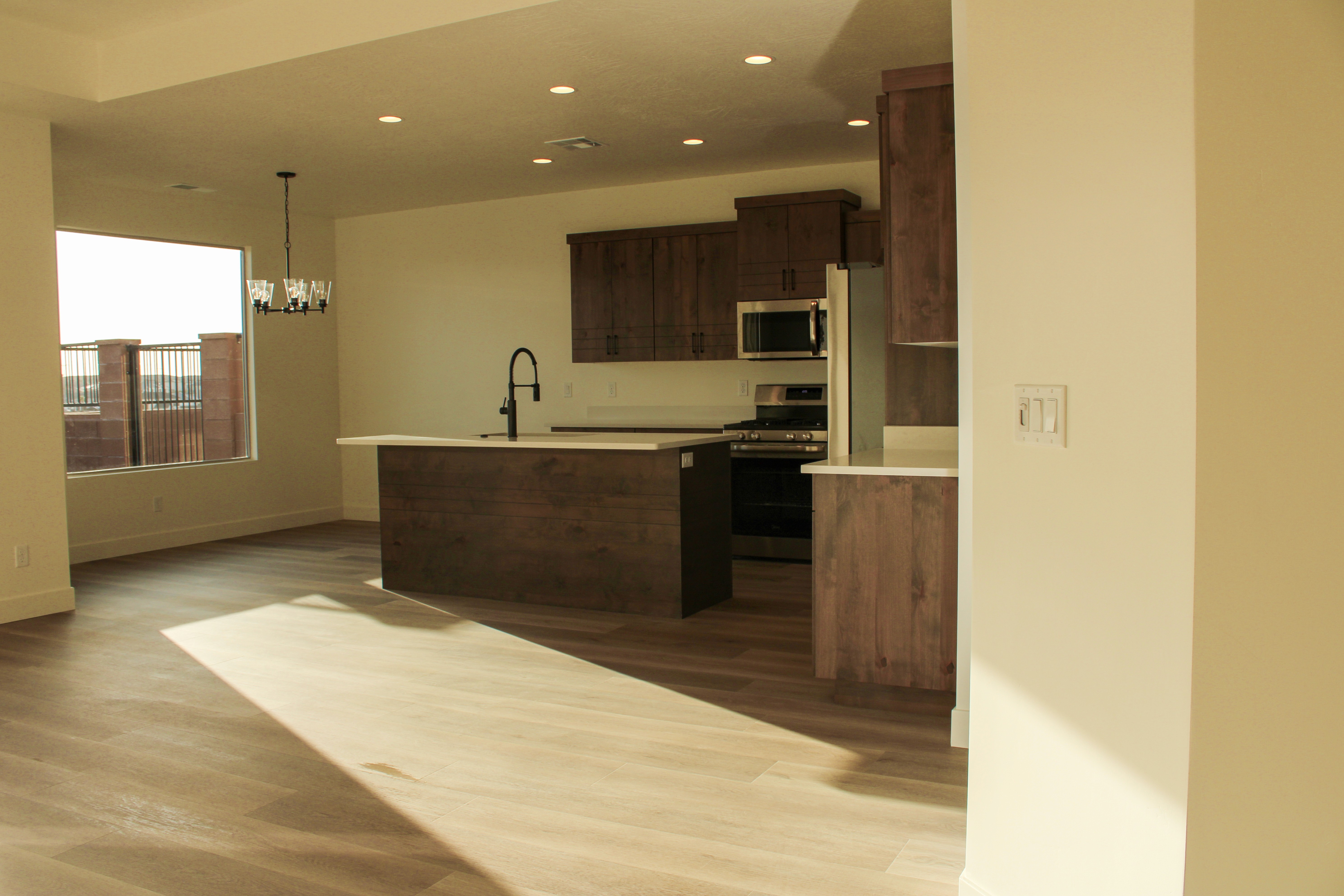 Dining space inside the Golden Hour home in Hurricane, Utah connected to the open kitchen layout.
