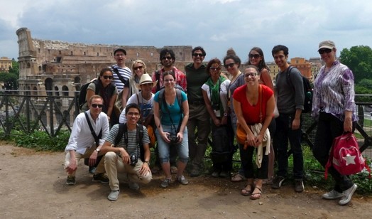 people group taking photo in front of coliseum