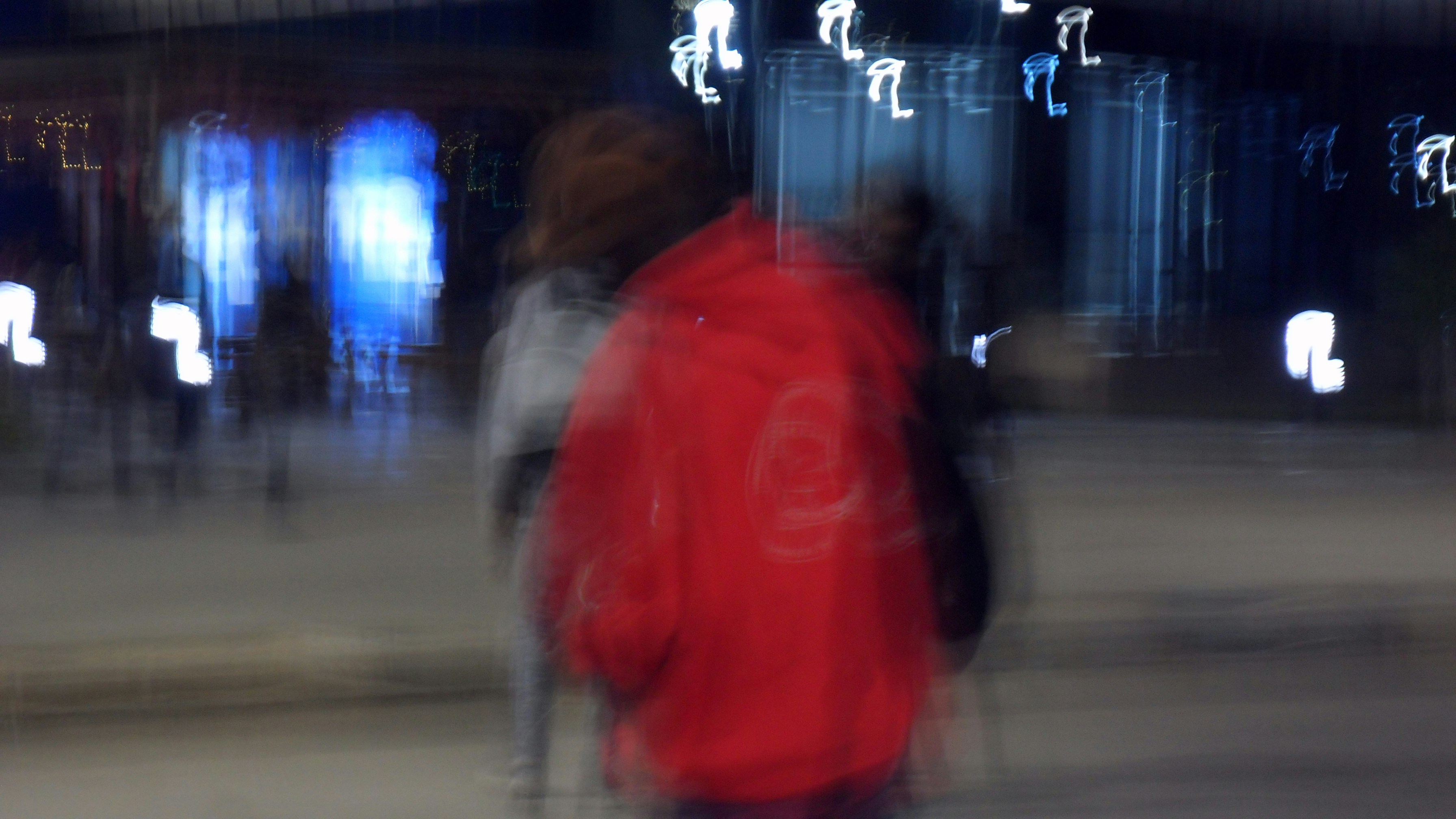 A blurry photo of a person walking down a street