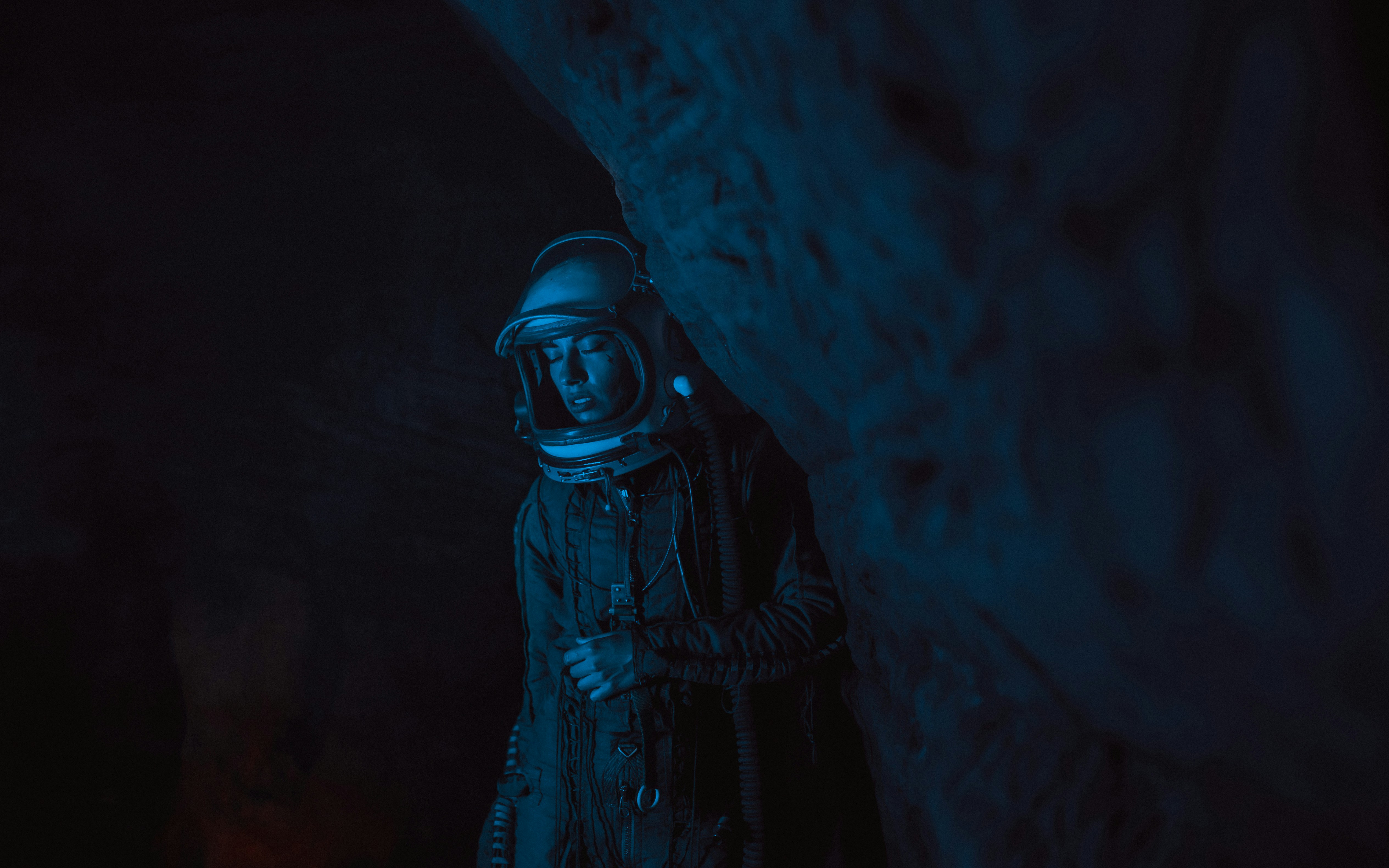 Person in a cave in blue light