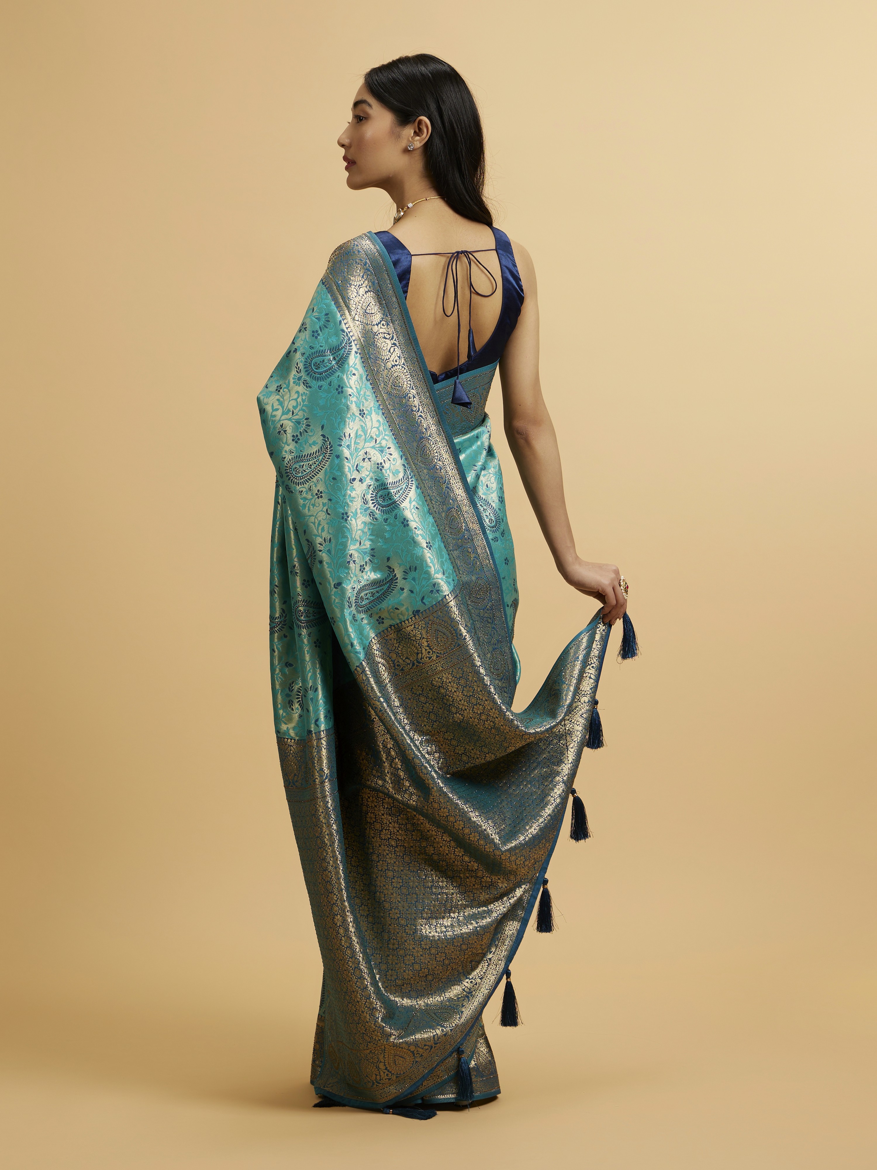 Green car under neon lights in a rainy city street