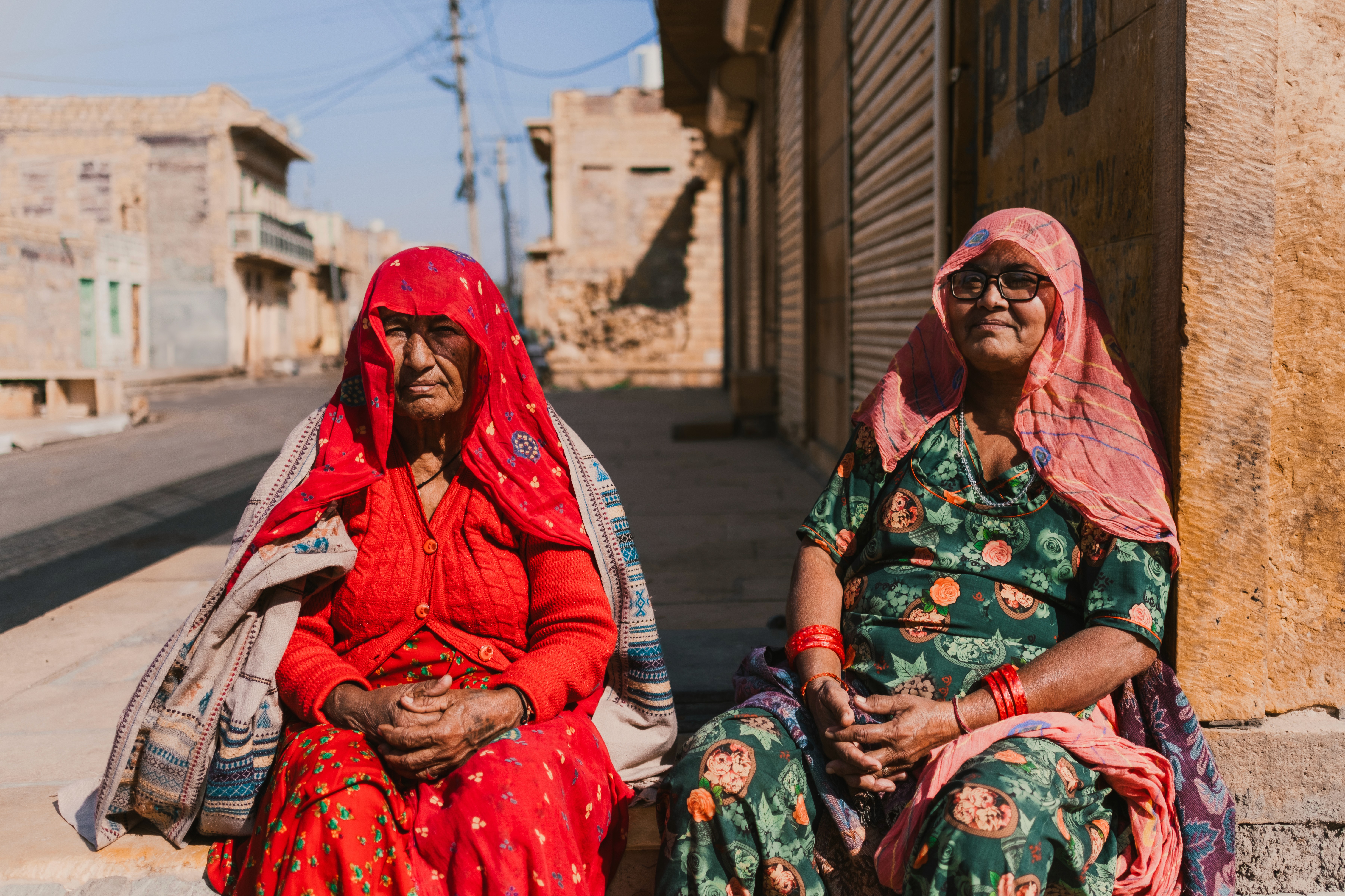 Two best friends sitting out on the street on a hot summer day in jaisalmer rajasthan