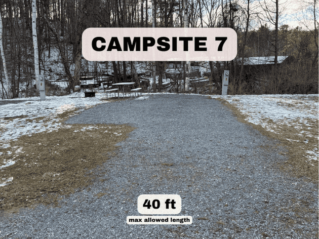 Campsite 7 at Pine Hollow Campground, a 40ft gravel RV site with dual pedestals and a picnic table