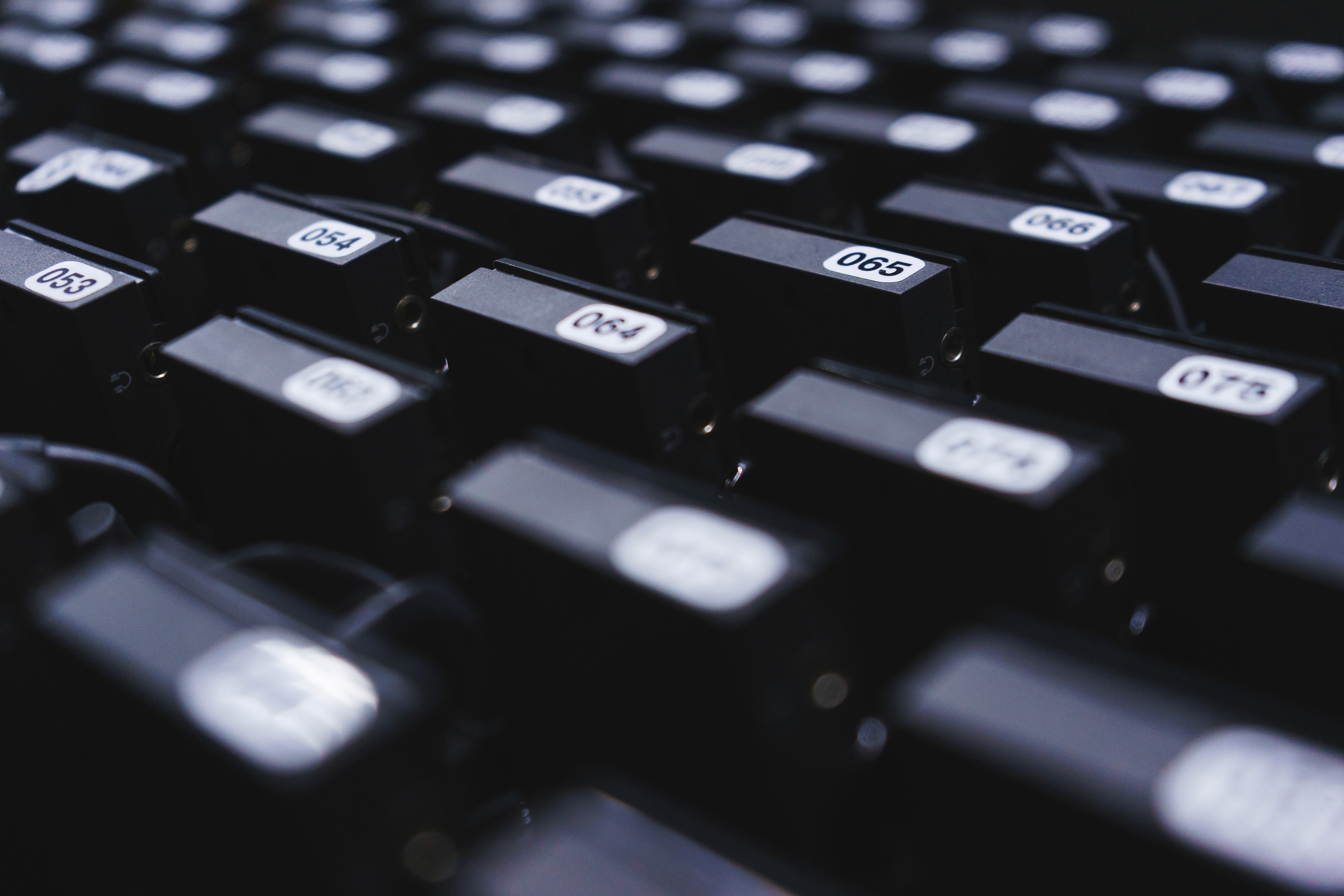 Modern indoor space with large glass doors, lush greenery, and a cozy seating area visible beyond.