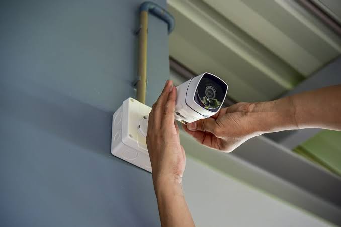 two bullet surveillance cameras attached on wall