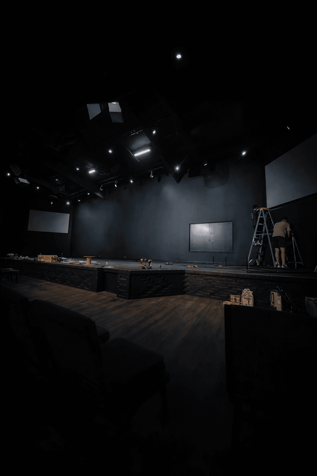 A serene outdoor lounge area with two chairs surrounded by lush greenery and natural light streaming in.