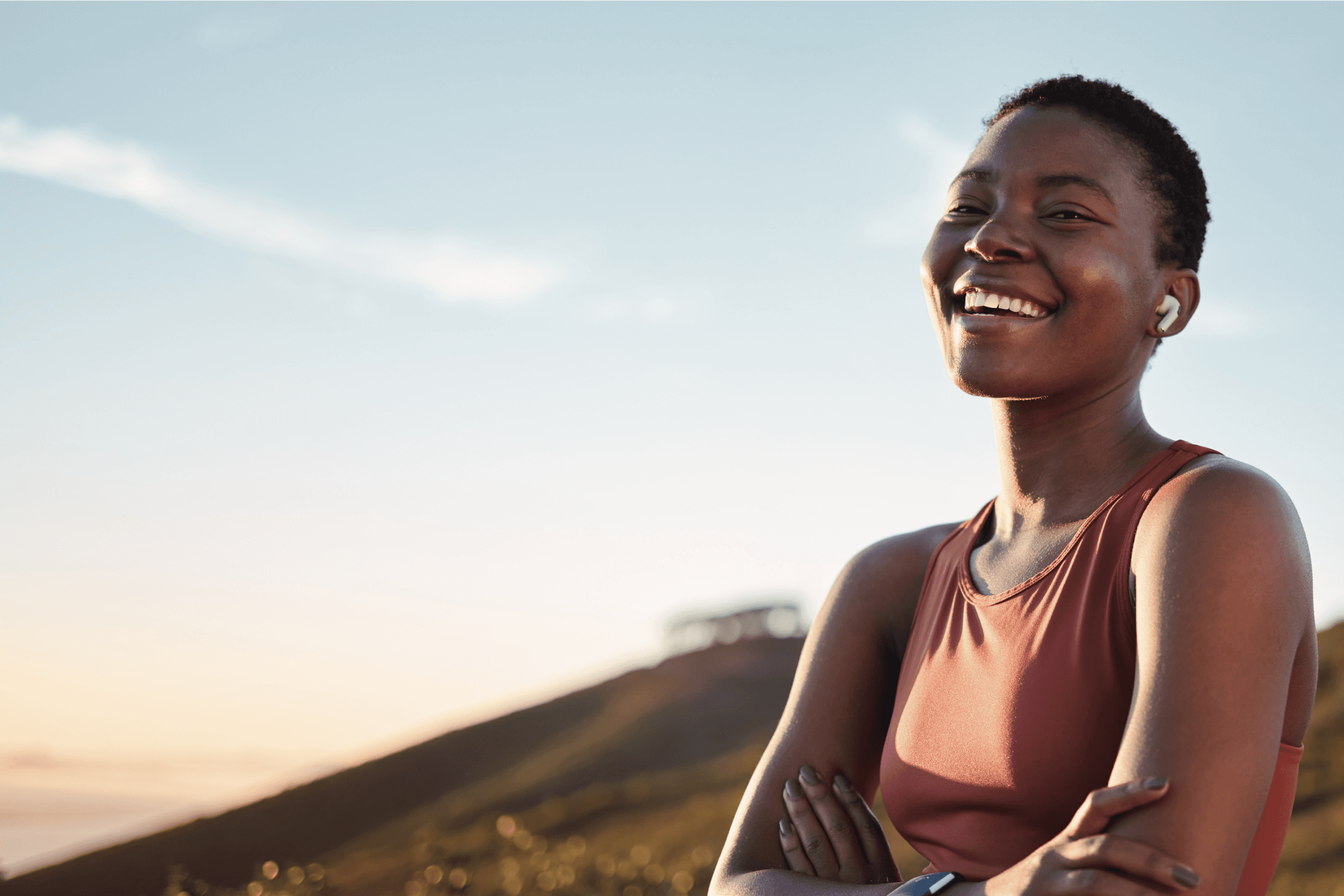 An image of a femal teacher smiling as she takes a break from her classwork. 