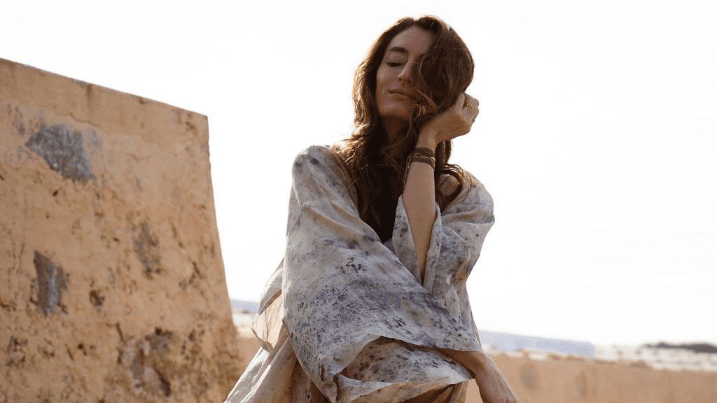 Woman leaning back in golden light with her face to the sky, reflecting how sex drive changes with age and grows more confident in midlife