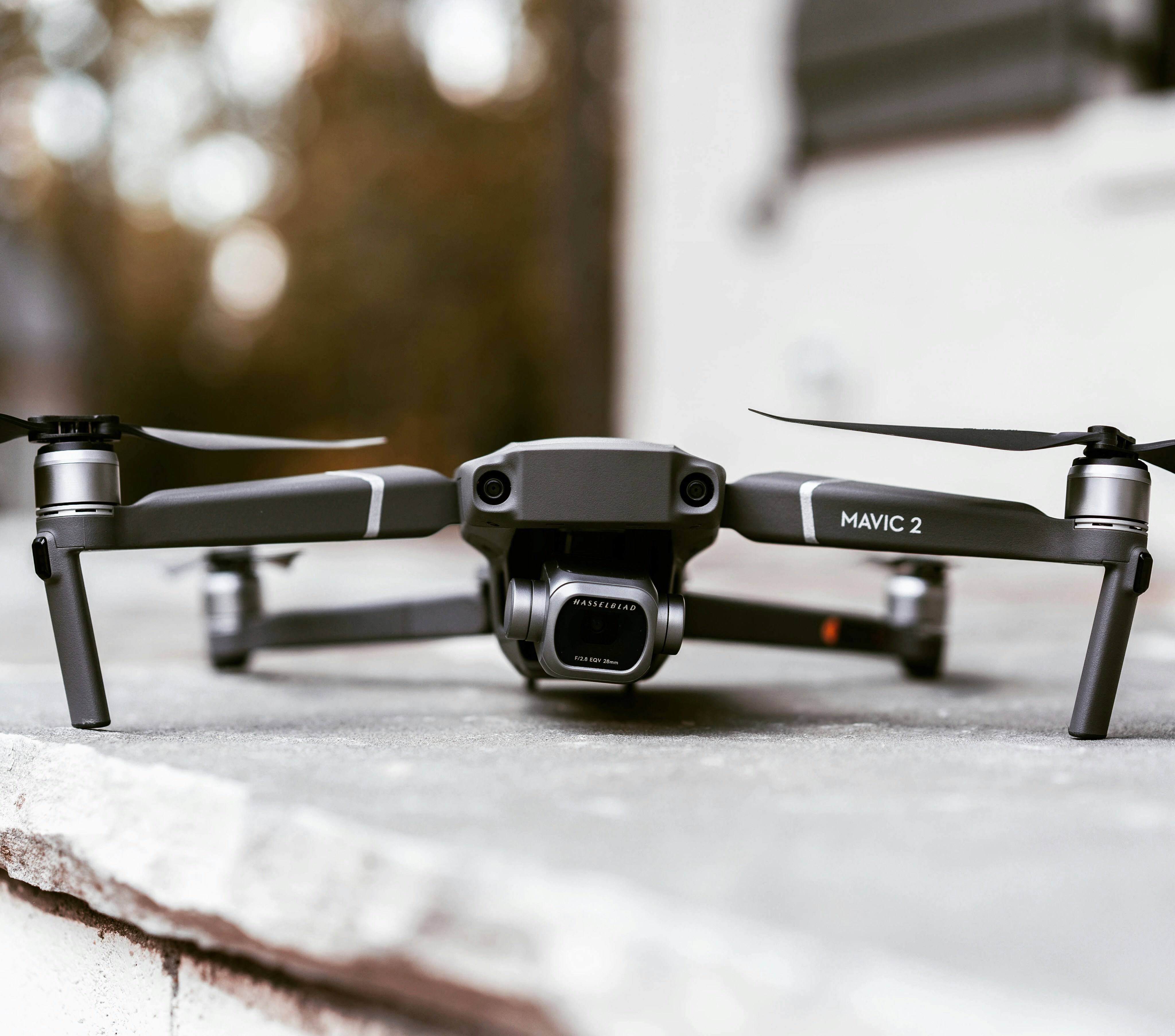 woman holding a phone and man looking at the phone. both are smiling