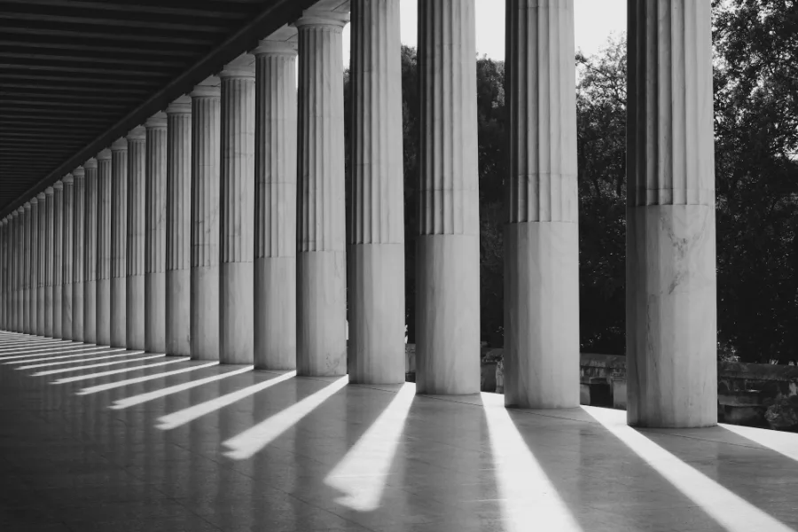 Stone colonnade with long shadows, black and white