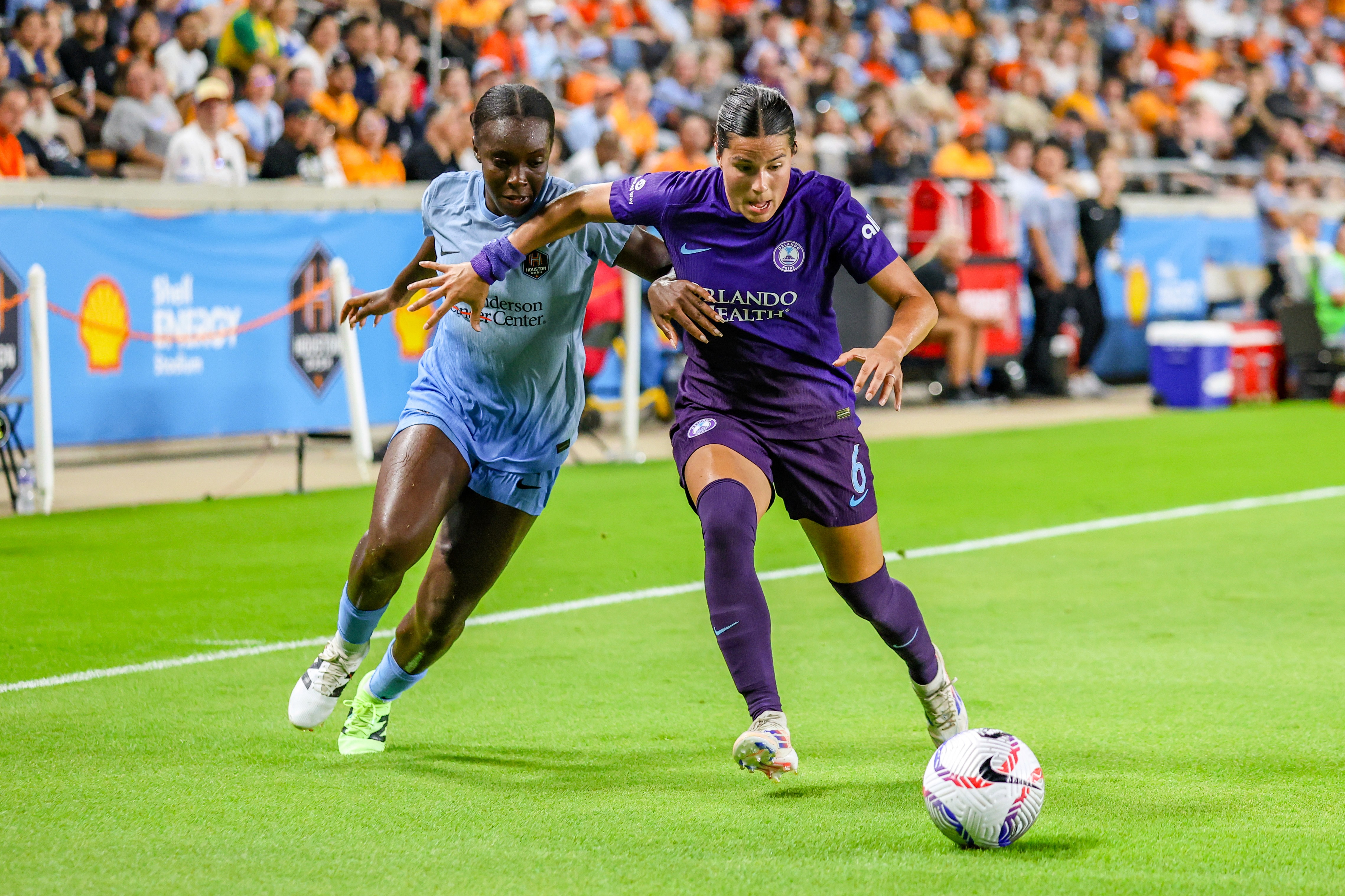 Michelle Alozie (11) of the Houston Dash challenges Emily Sams (6) of the Orlando Pride during an NWSL game between the Houston Dash and the Orlando Pride at Shell Energy Stadium on August 23, 2024 in Houston. (Photo by Parker George/Undrafted)