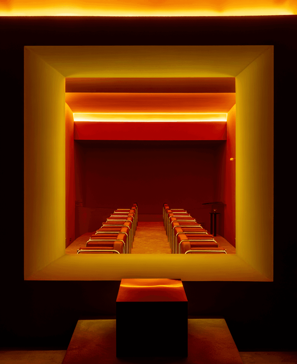 A presentation taking place in a modern, plant-filled event space with a wooden ceiling.