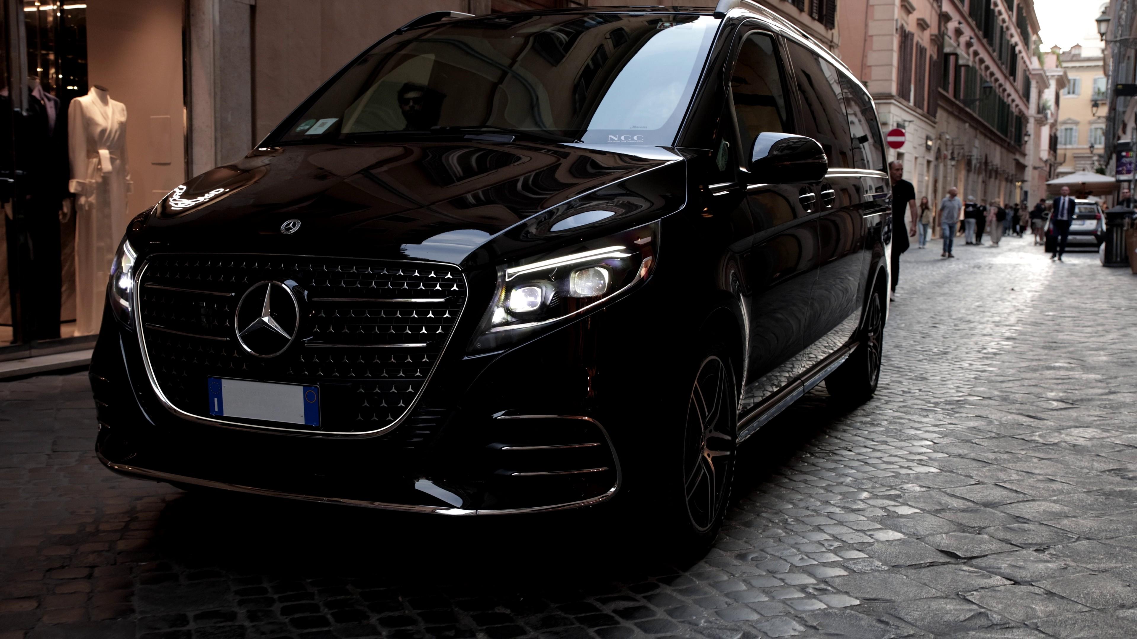 Close up of a Mercedes V-class van driving along a cobblestone road in Italy
