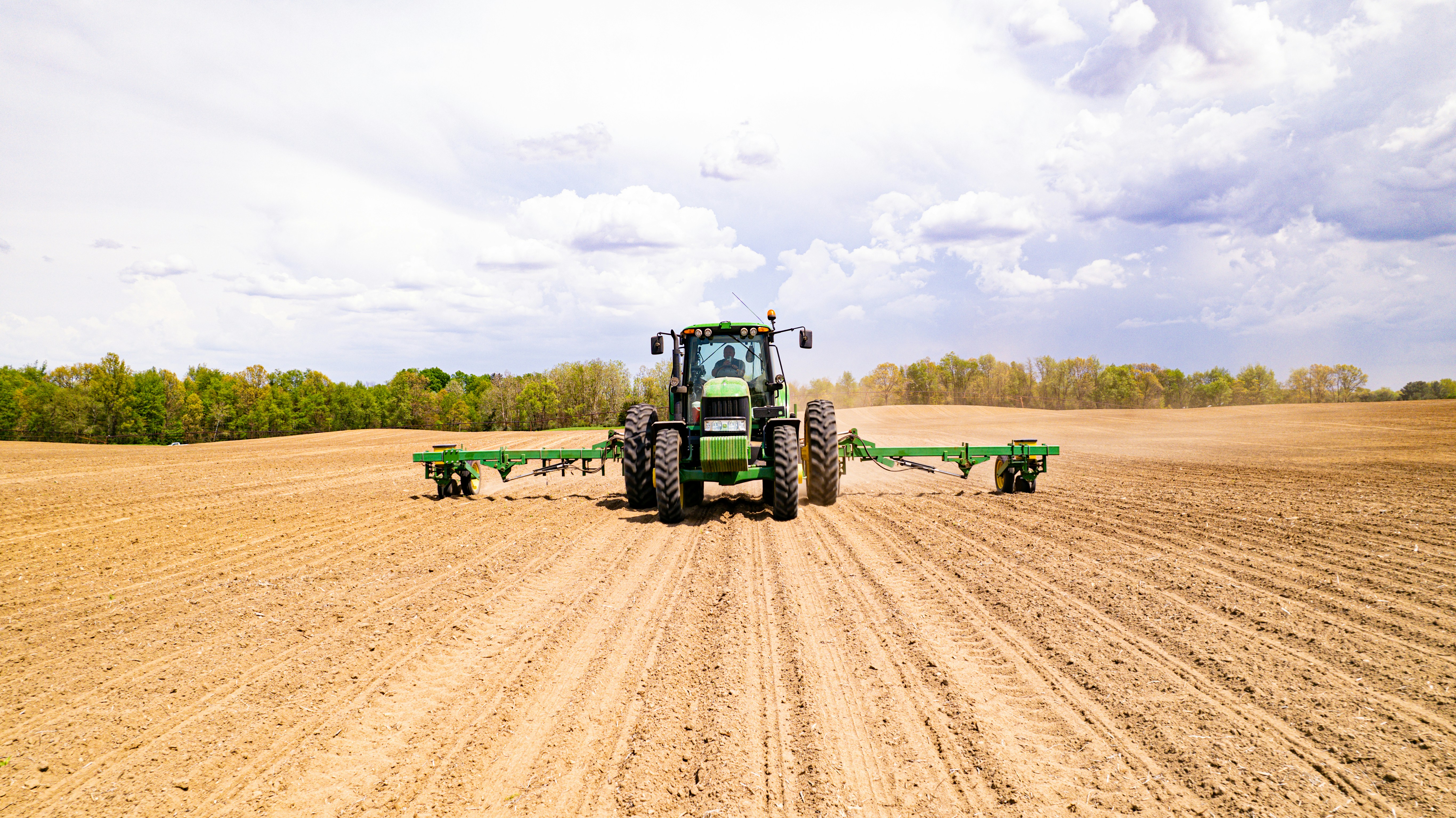 a tractor driving on a dirt road