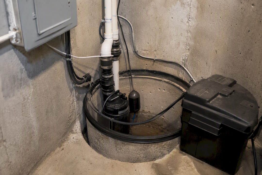 Sump pump and battery backup in basement pit