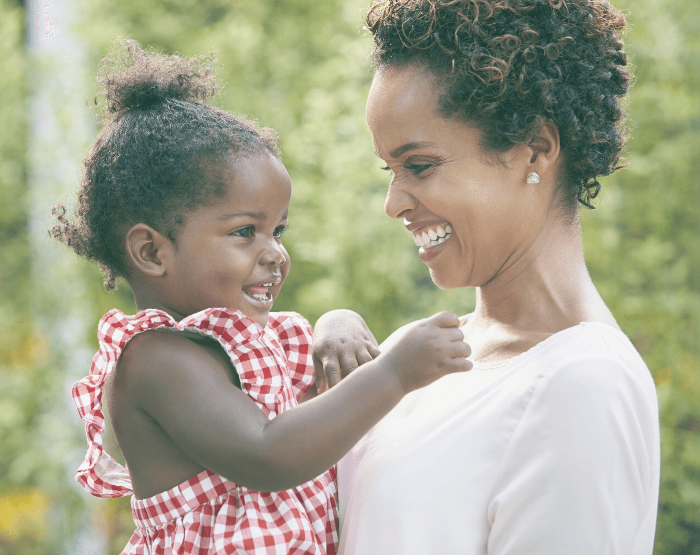 woman holding a phone and man looking at the phone. both are smiling