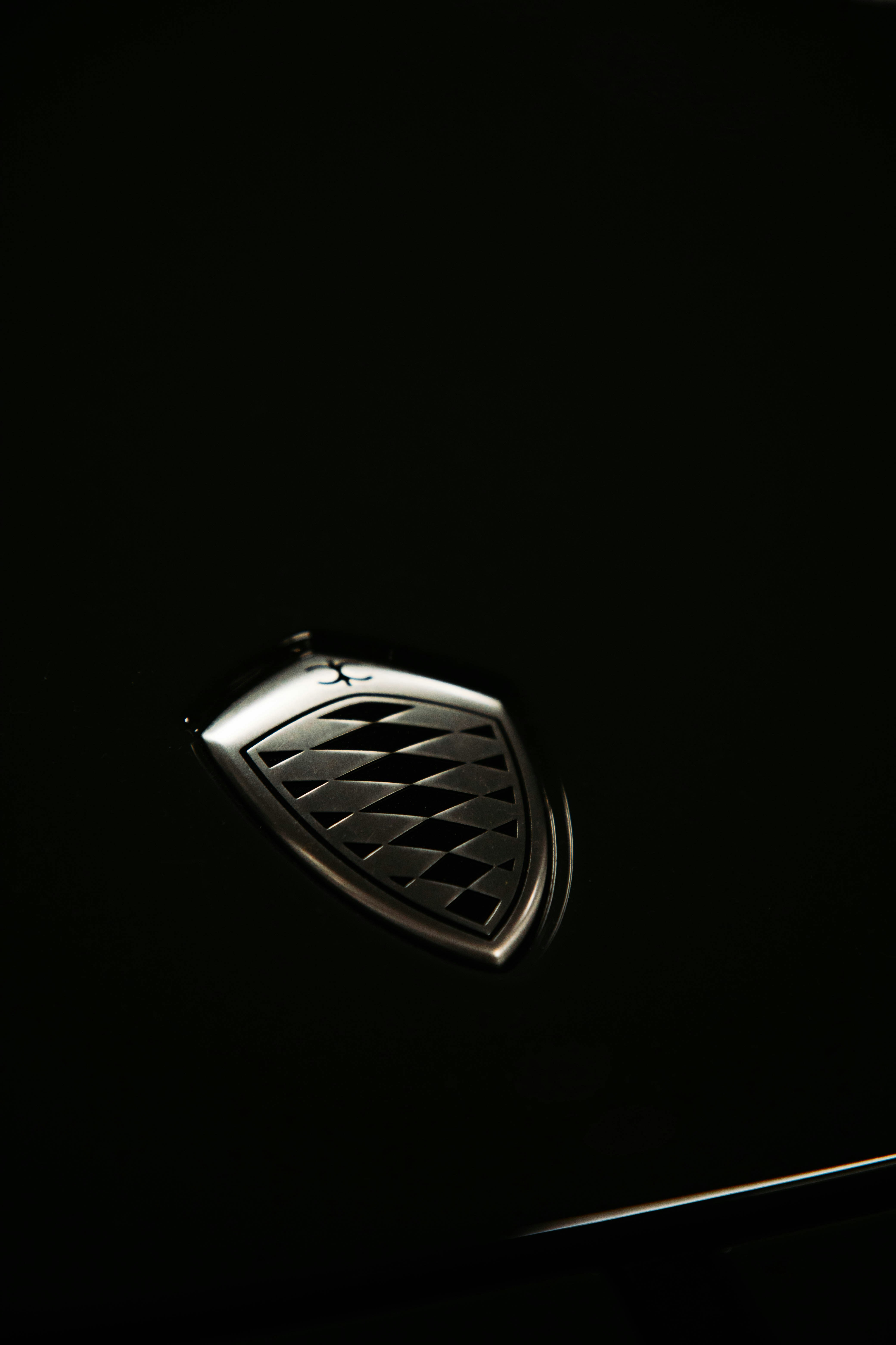 a close up of a car's emblem in the dark