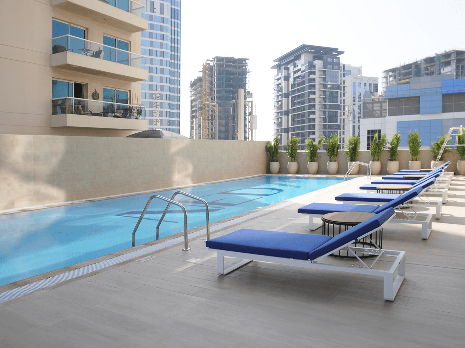 Canal Bay by NED infinity pool overlooking the waterfront — exclusive luxury amenities in Business Bay Dubai. Buy real estate with crypto on Tylt.