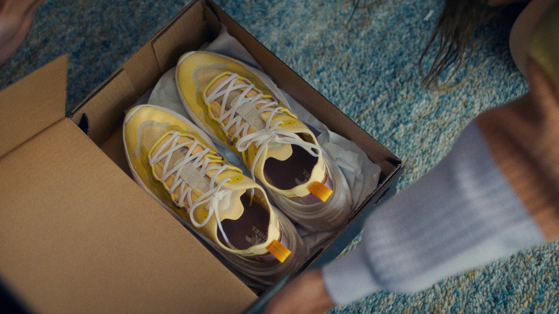 Close-up of Sorel box opening to reveal incredible yellow sneakers