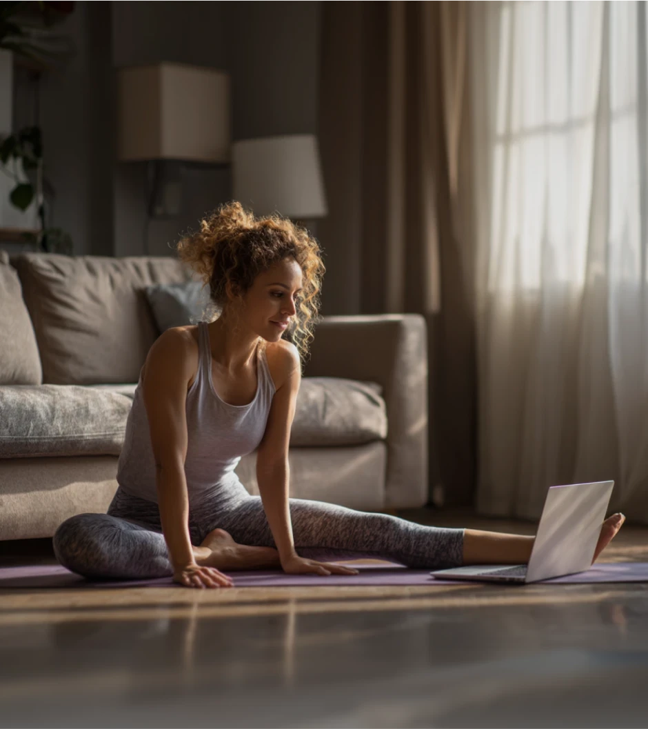 Woman stretching in her living room on a yoga mat