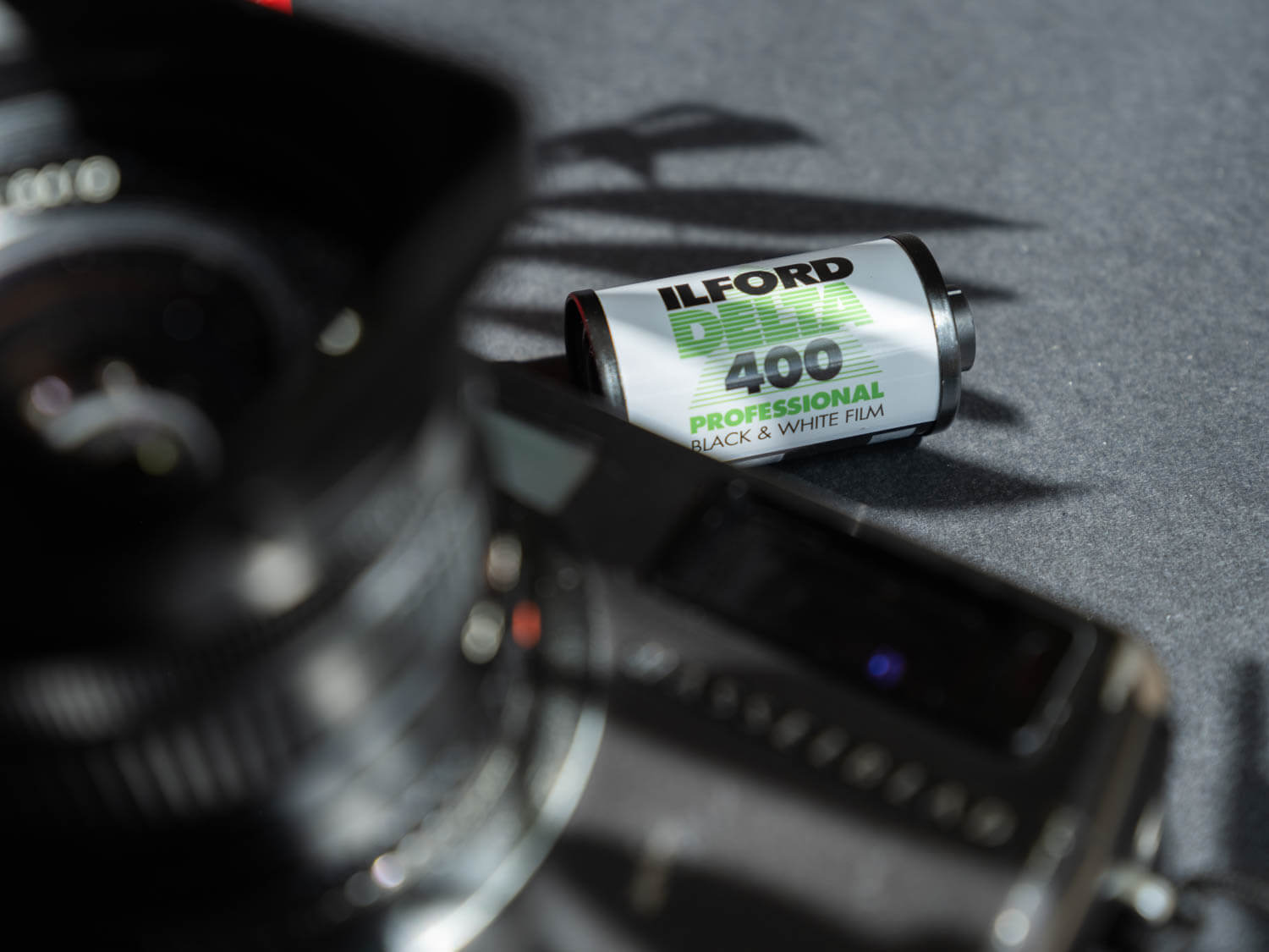  Ilford delta together with the Hasseblad XPan laid out as a to go film kit for travel photography