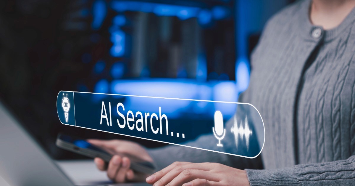 woman AI searching on a computer with a cell phone in her hand